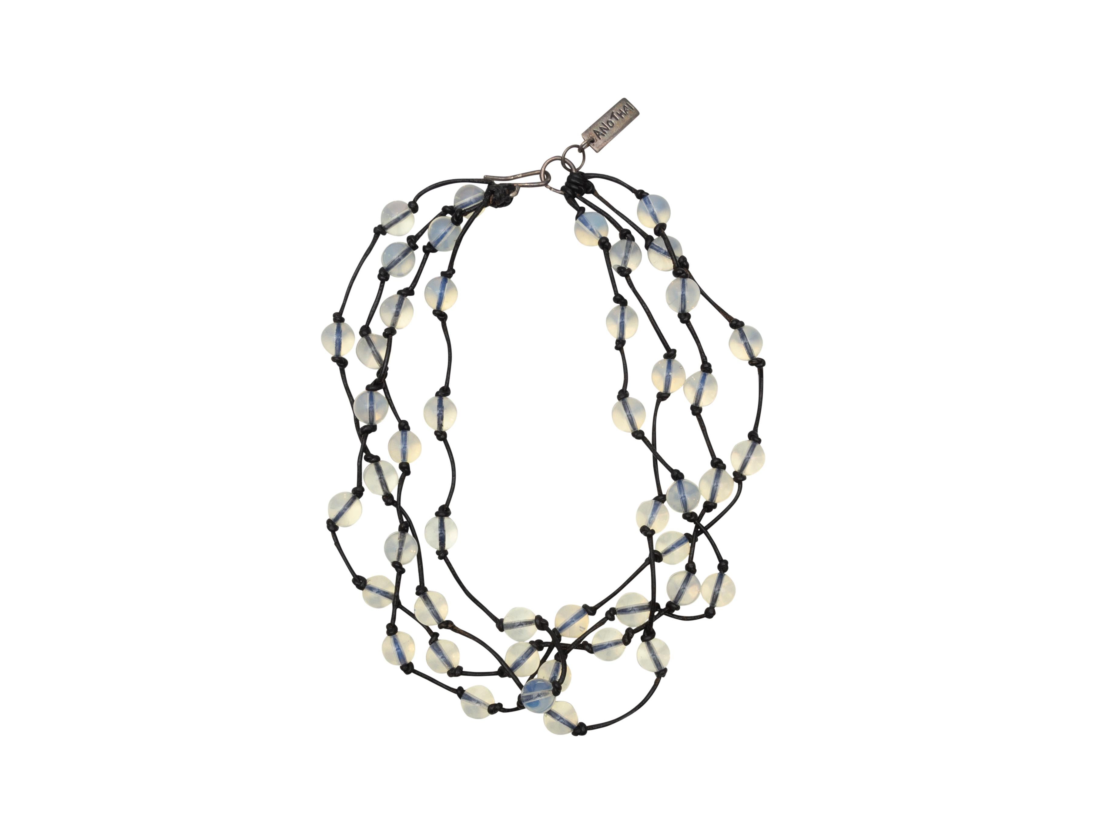 Product details: Light blue quartz and black knotted cord multistrand necklace by Anothai Hansen. Hook closure. 15