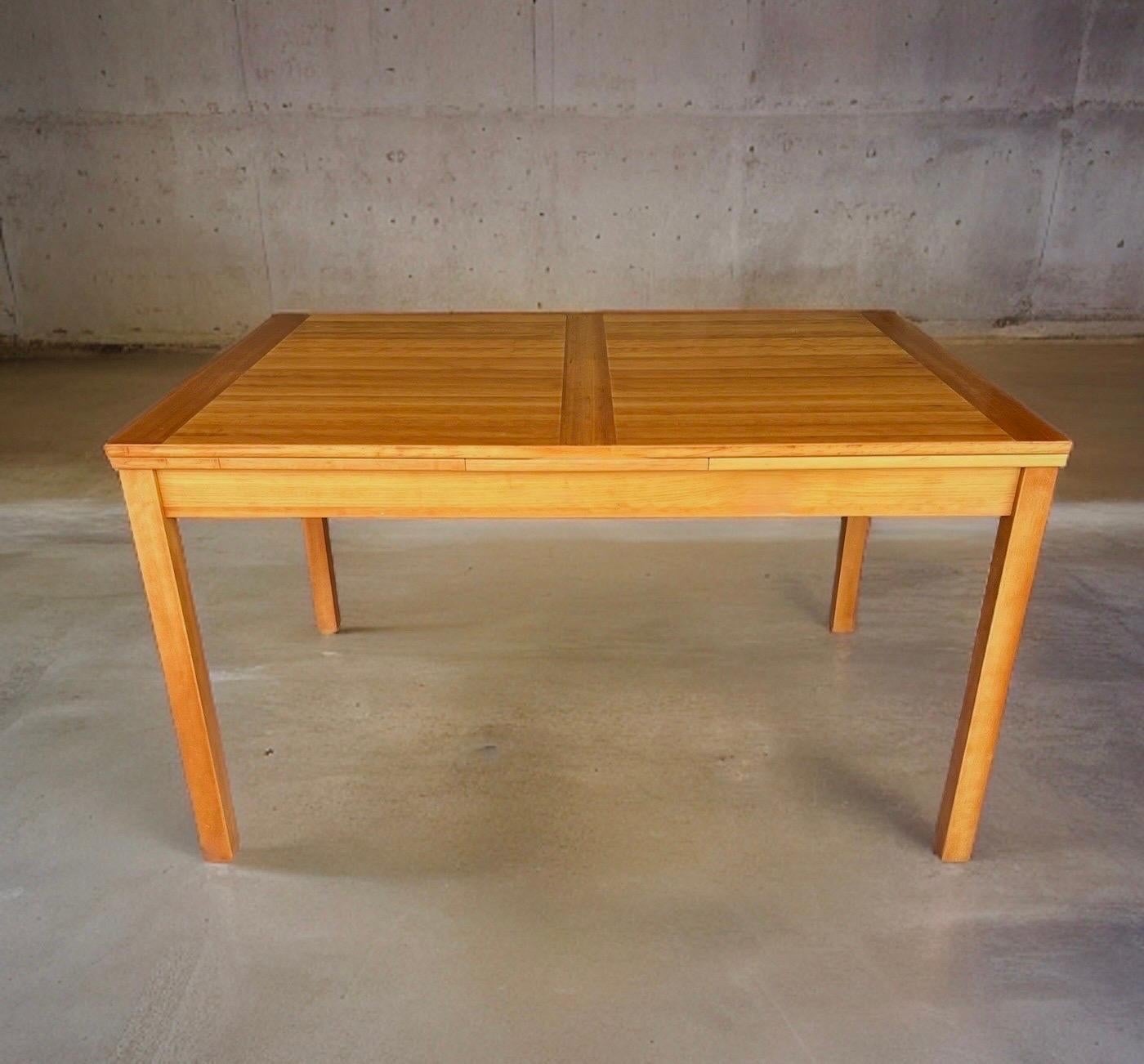Ansager Mobler Mid Century Teak Draw Leaf Table .

Seats 6 comfortably but easily expands to seating 8-10 with two hidden pull-out leaves that slide smoothly beneath the table top.  

Constructed from premium solid and veneered teak.  This