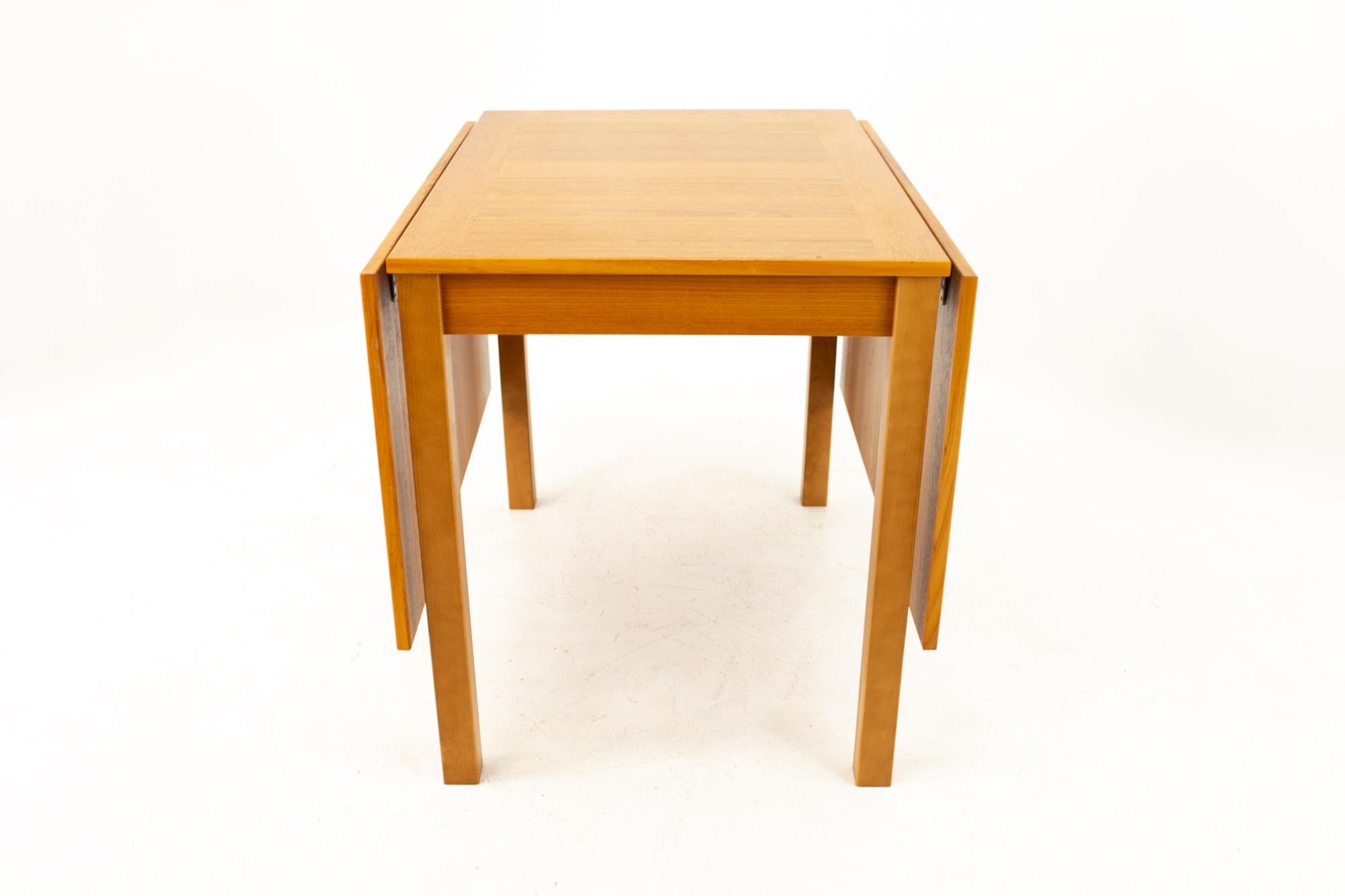 Ansager Mobler Mid Century teak drop leaf expanding dining table

Table without leaves measures: 25 wide x 35.5 deep x 29.5 high 
Table with leaves measures: 65 wide x 35.5 deep x 29.5 high

This piece is available in what we call restored vintage
