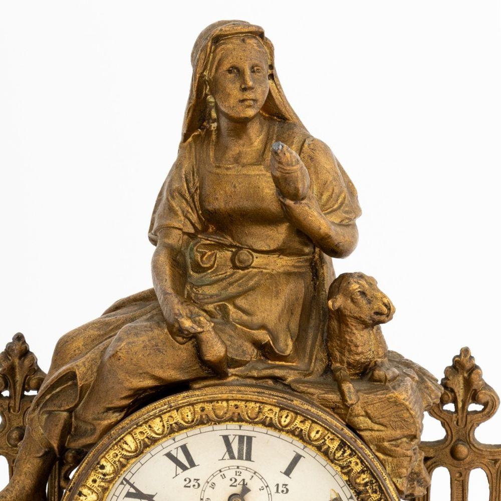 Ansonia Gilt Metal Figural Mantel Clock, 19th century, with seated maiden and sheep finial on pierced scroll and crest form base. 13.5