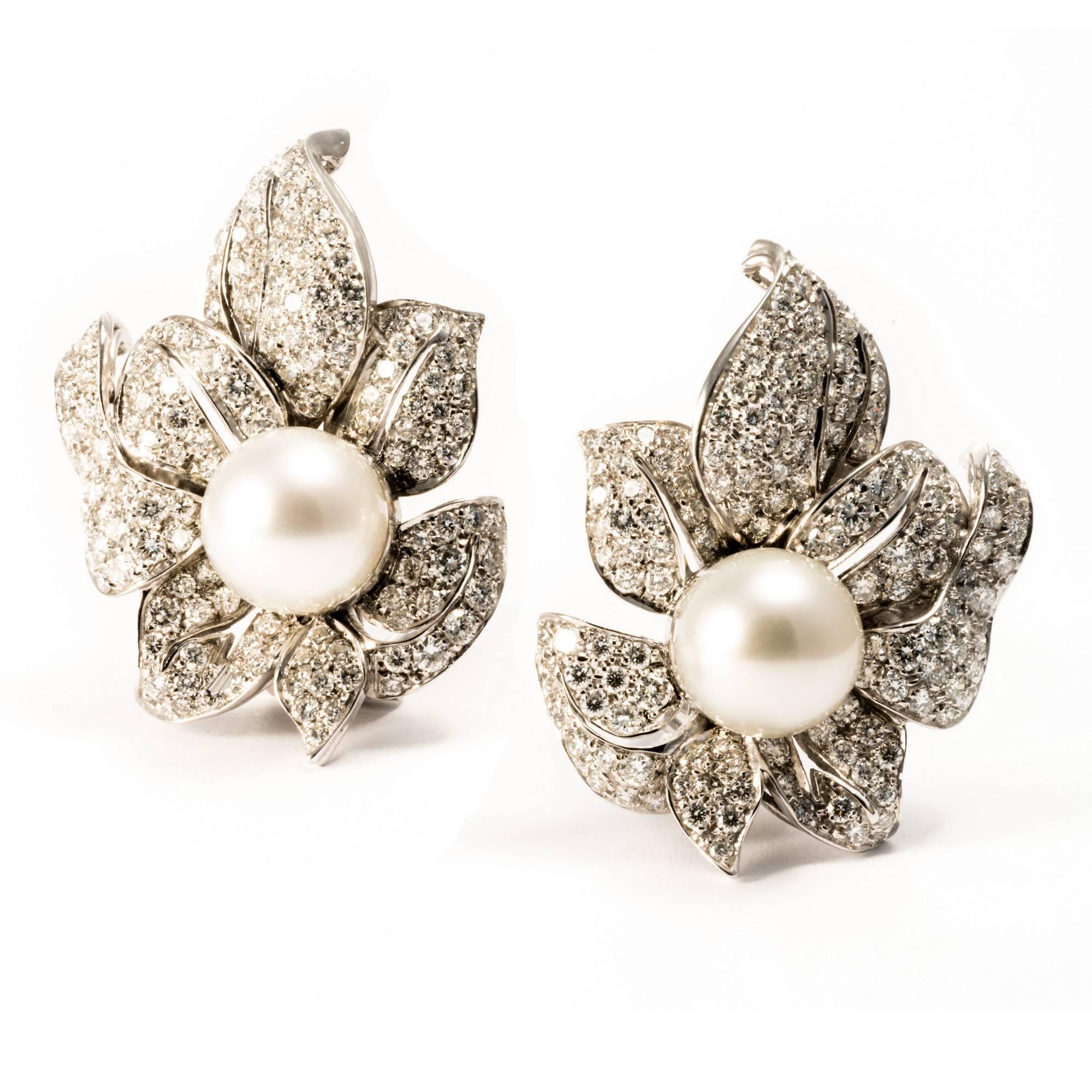 These one-of-a-kind earrings made in 18 K white gold  show a beautifully shaped orchid encrusted by 284 diamonds enhanced by 2 large white Australian natural pearl, diameter  10 mm.  Total diamonds weight is  4.93 carats