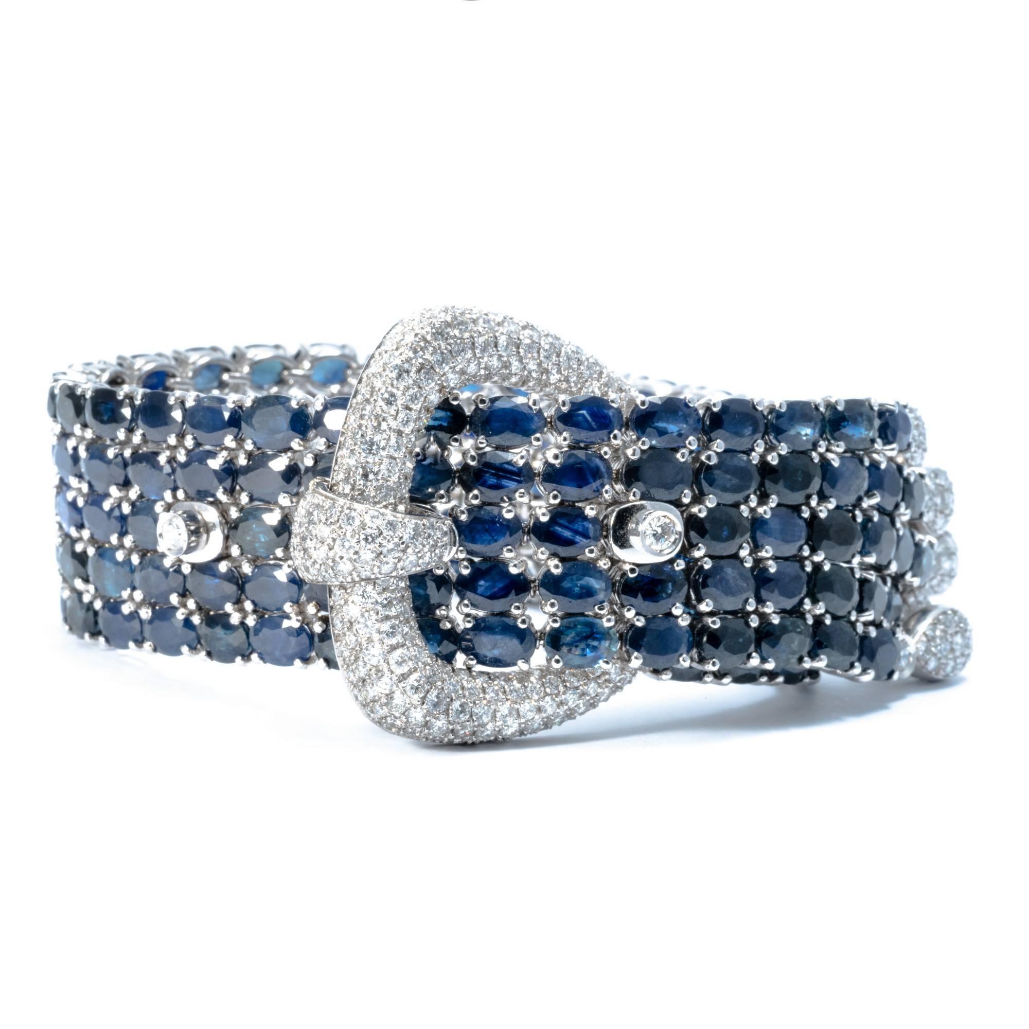 Ansuini sapphires and diamonds buckle bangle in white gold 18 k is composed of 5 threads of sapphires, enlightened by a buckle and a cascade of drops, all encrusted with diamonds. It’s  extraordinary construction and beautiful stones make this