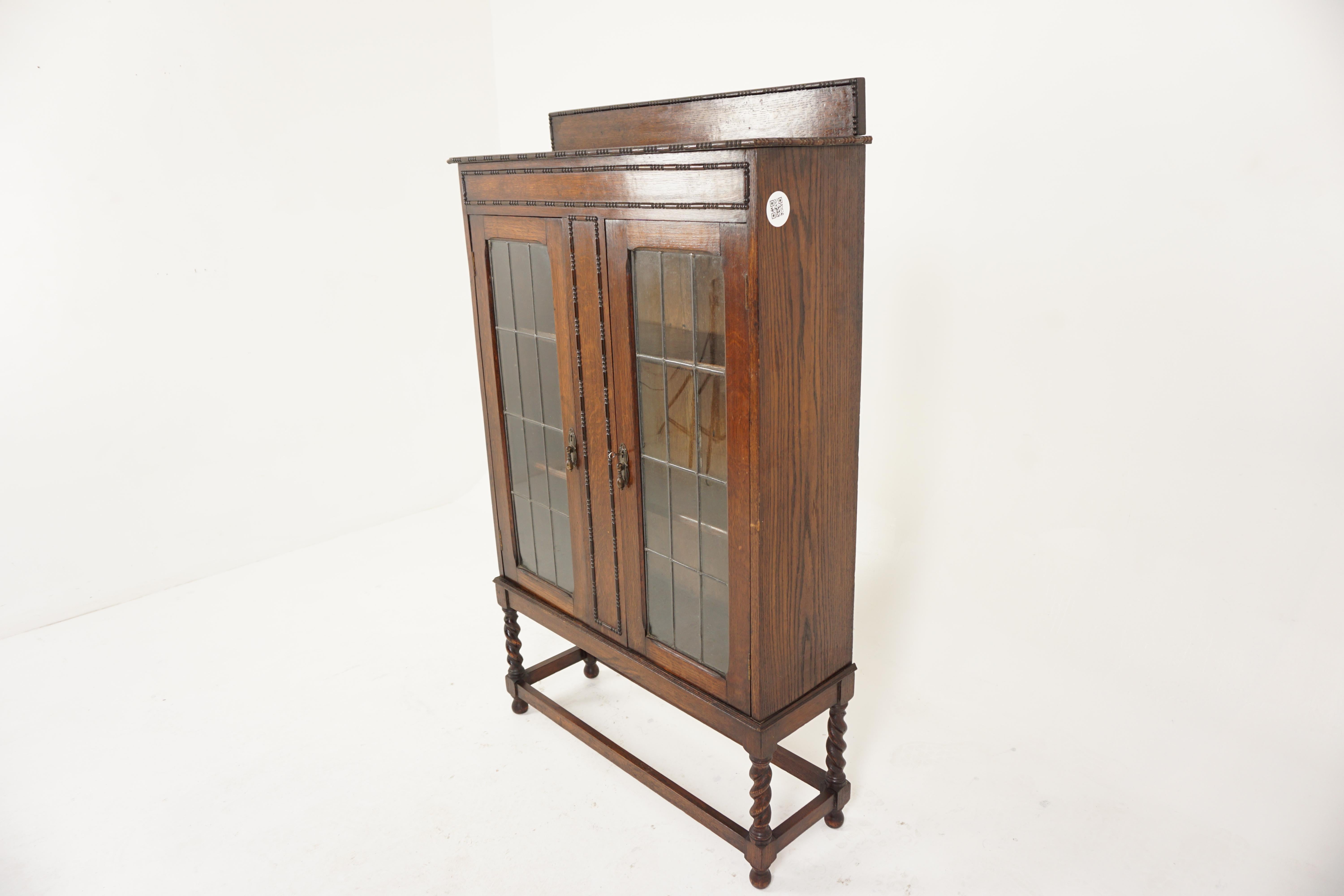 Antique Leaded Glass Barley Twist Oak bookcase, display cabinet, Scotland 1910, H811

Scotland 1910
Solid Oak
Original finish
Pediment with beading on front
Rectangular moulded top with beading
Center panel flanked by a pair of leaded glass