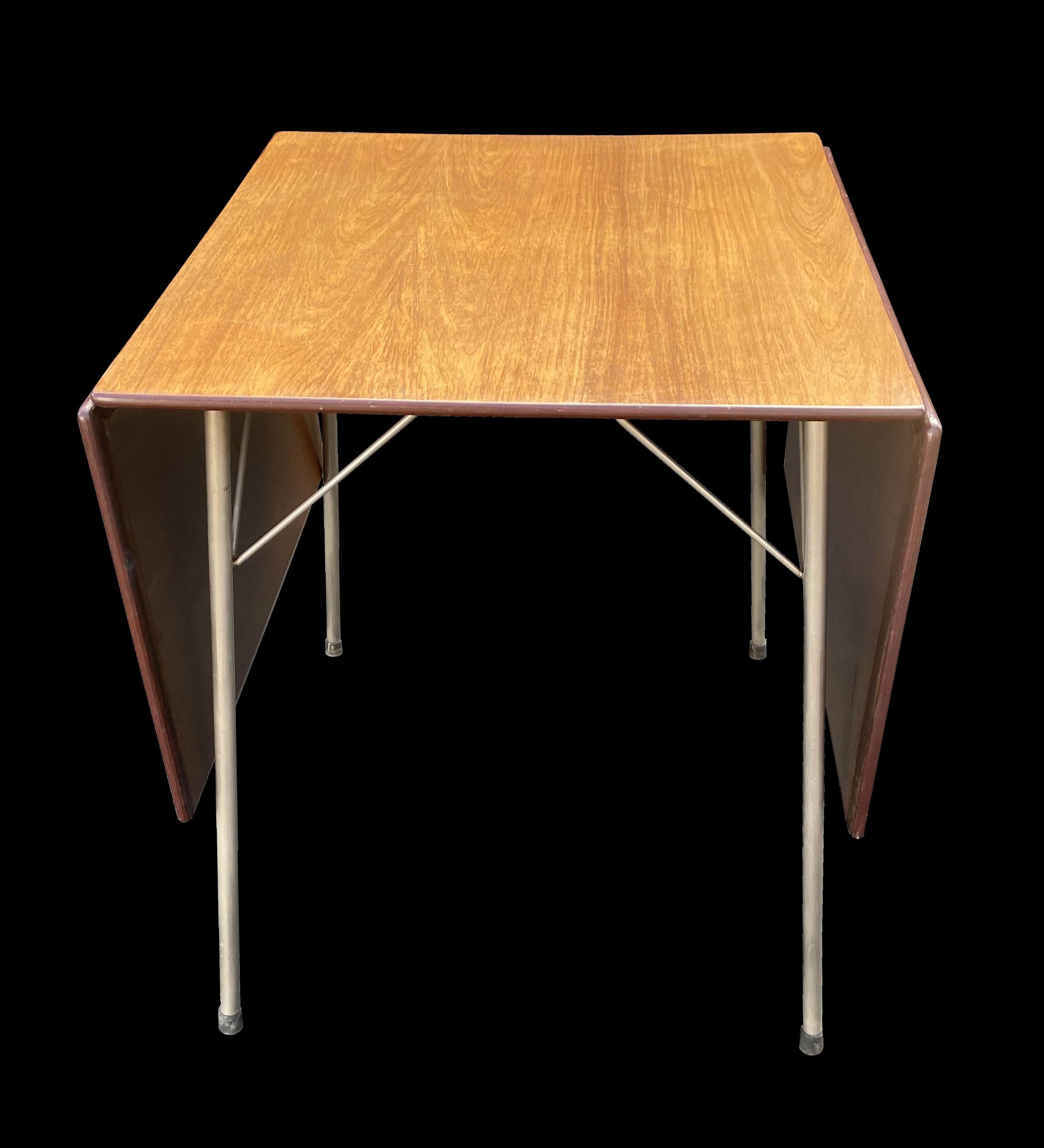 This is an excellent. untouched original example of this drop leaf dining table designed by Arne Jacobsen, the top has a wonderful patina, and the Rosewood has nicely and evenly faded to a really lovely mellow color.
It is 60 mcm wide with no flaps