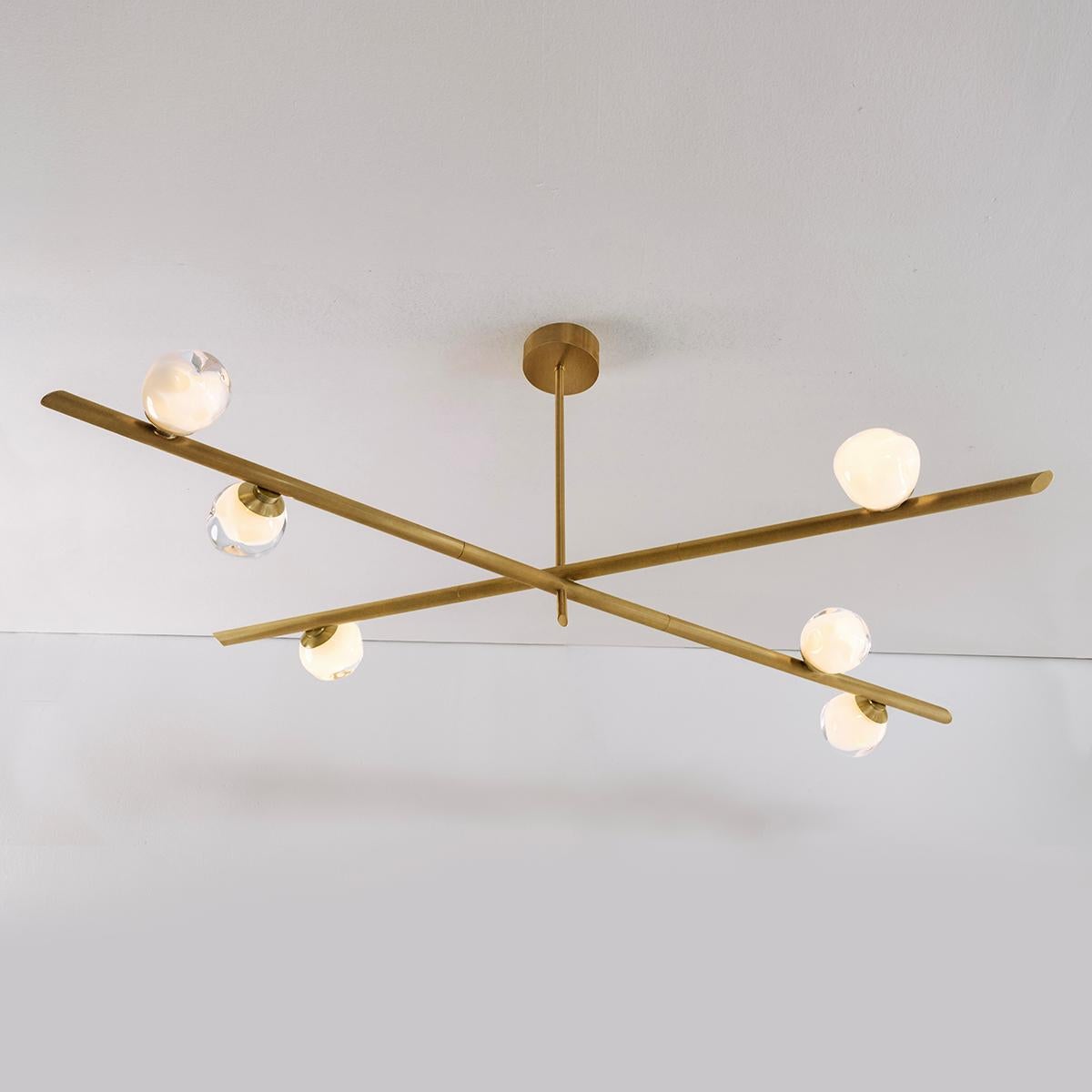 The Antares ceiling light harmoniously balances the linear details of its intersecting arms with the organic form of its handblown glass shades. The first image shows the fixture in our Bronzo Nuvolato specialty finish-subsequent pictures are in the