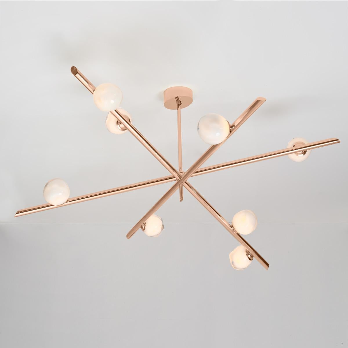 The Antares X3 ceiling light harmoniously balances the linear details of its intersecting arms with the organic form of its handblown glass shades. The first images show the fixture in our polished copper finish-subsequent pictures show it in a
