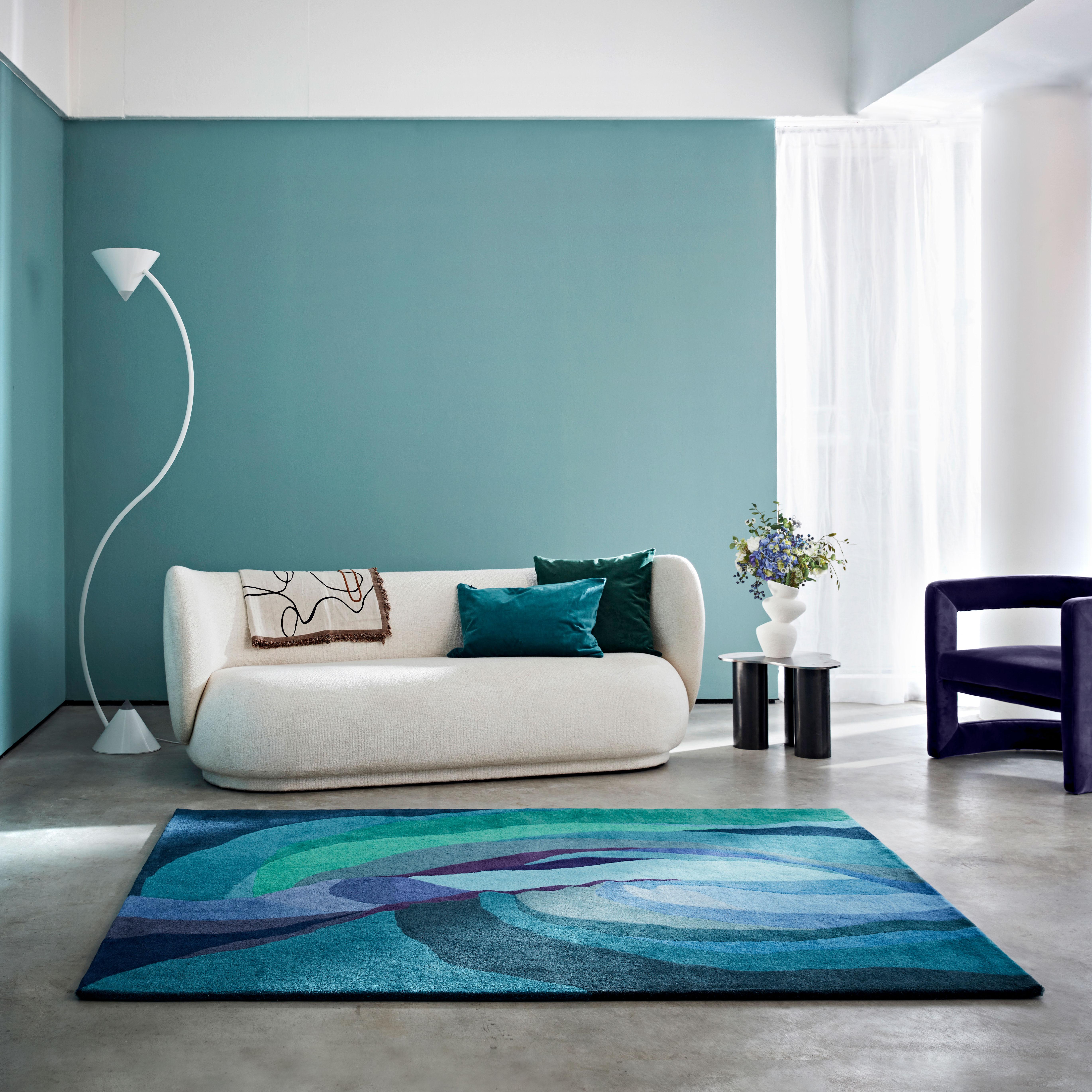 This tranquil blue and green rug is inspired by the stunning ’slot canyon’ in Arizona. The design is created around a central light pouring in through the top gap in the aged rock and creating a multitude of mixing blue and green colours. The