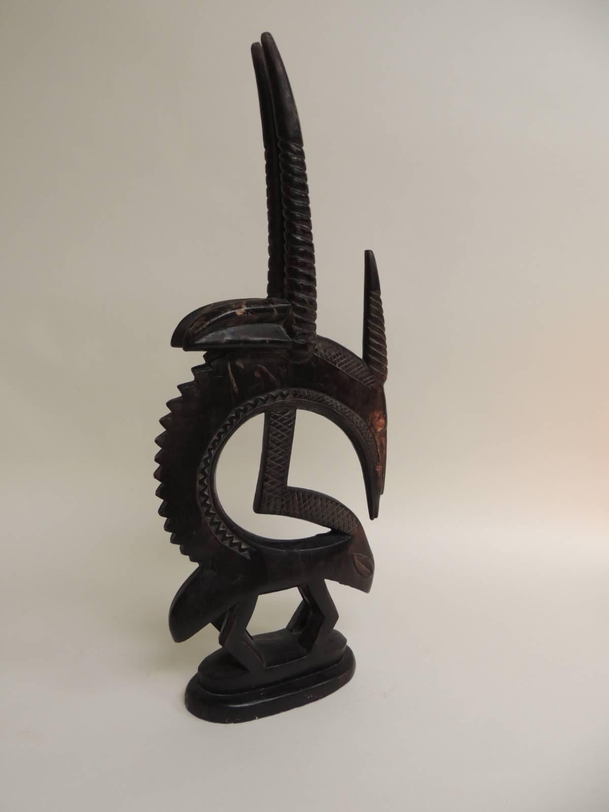 Bamana Antelope Chi Wara Head-crest African sculpture in terracotta
Primitive Art.
This tall sculptural antelope is a rare (heavy) composition piece. Solid forged iron cover with terracotta and finished in a bronze patina. Signed: Austin