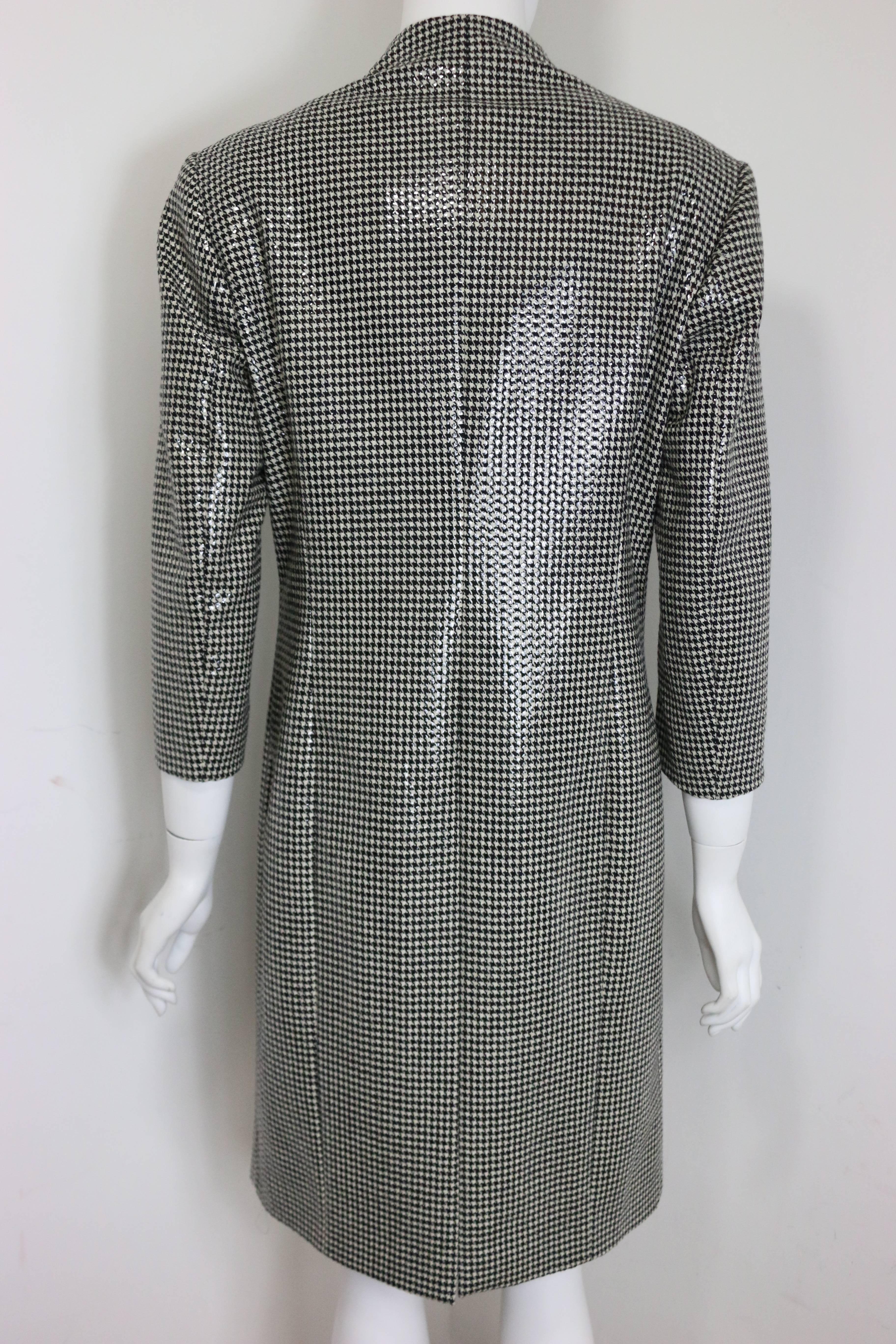 - Anteprima black and white houndstooth wool long coat with transparent sequin on top. It makes the coat look shinny. 

- Featuring front and back slit, stand collar, two side pockets, 3/4 quarters sleeves and one button closure.  

- Size 42. 

-
