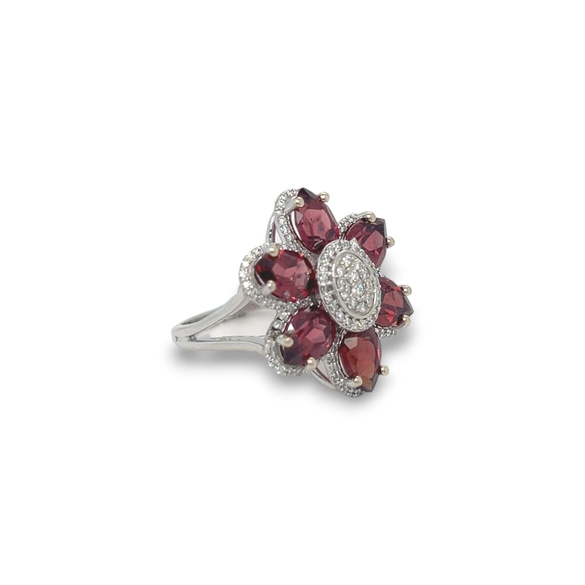 This stunning cocktail ring features a 5.69 carat anthill garnet with 0.62 total carat of diamonds. The diamonds are H/I in color and SI in clarity. Crafted in 14k white gold. Ring can be sized upon purchase.