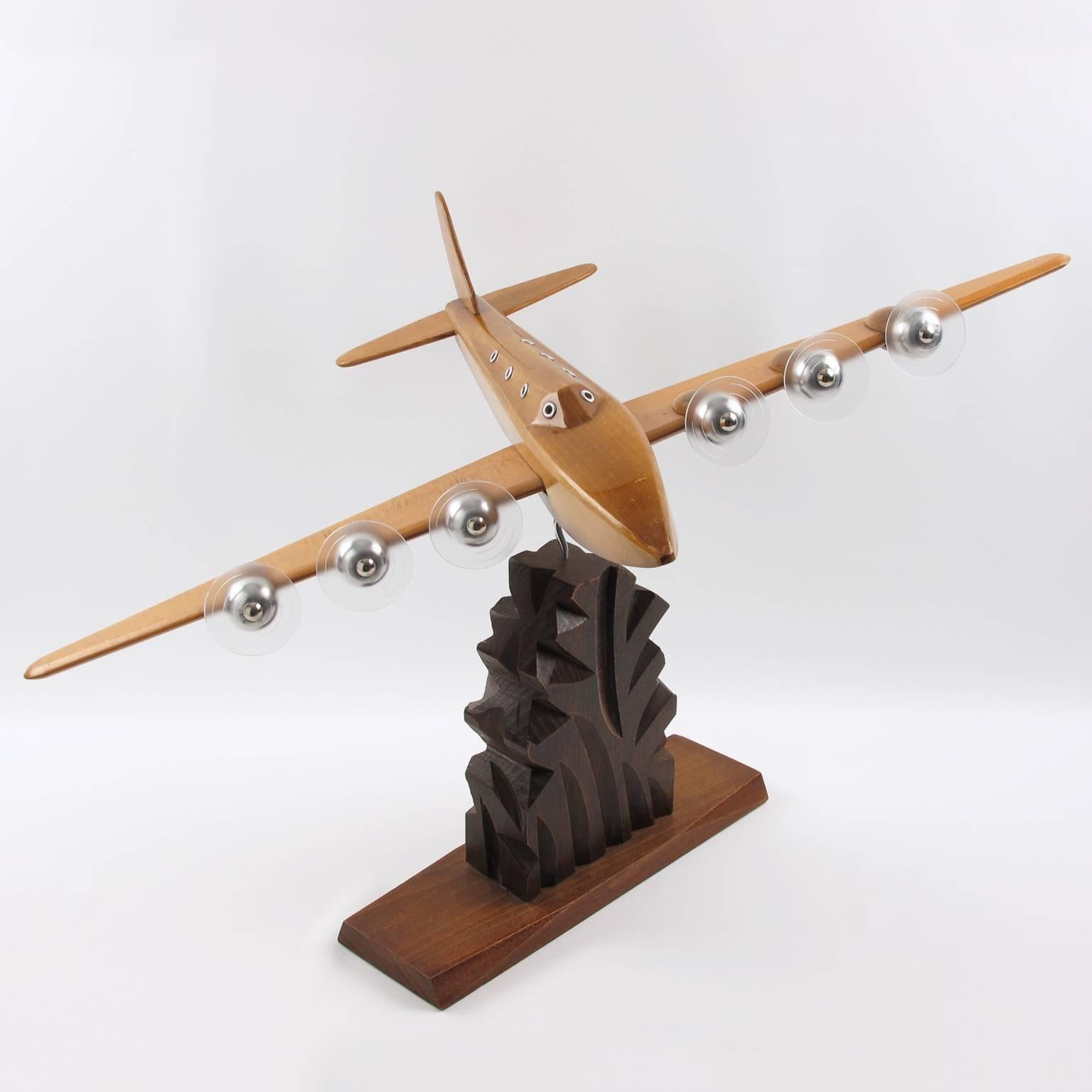 Stylish Art Deco wooden airplane model, mounted on a stylized wooden plinth by Anthoine Art Bois Studio. This large Art Deco Model airplane is made with solid light varnish wood and chromed metal accents. It has six Lucite propellers (note original