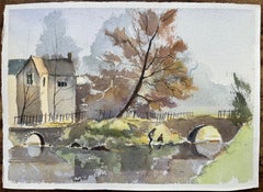Acuarela impresionista británica de una casa junto al río y un puente de arco en otoño
