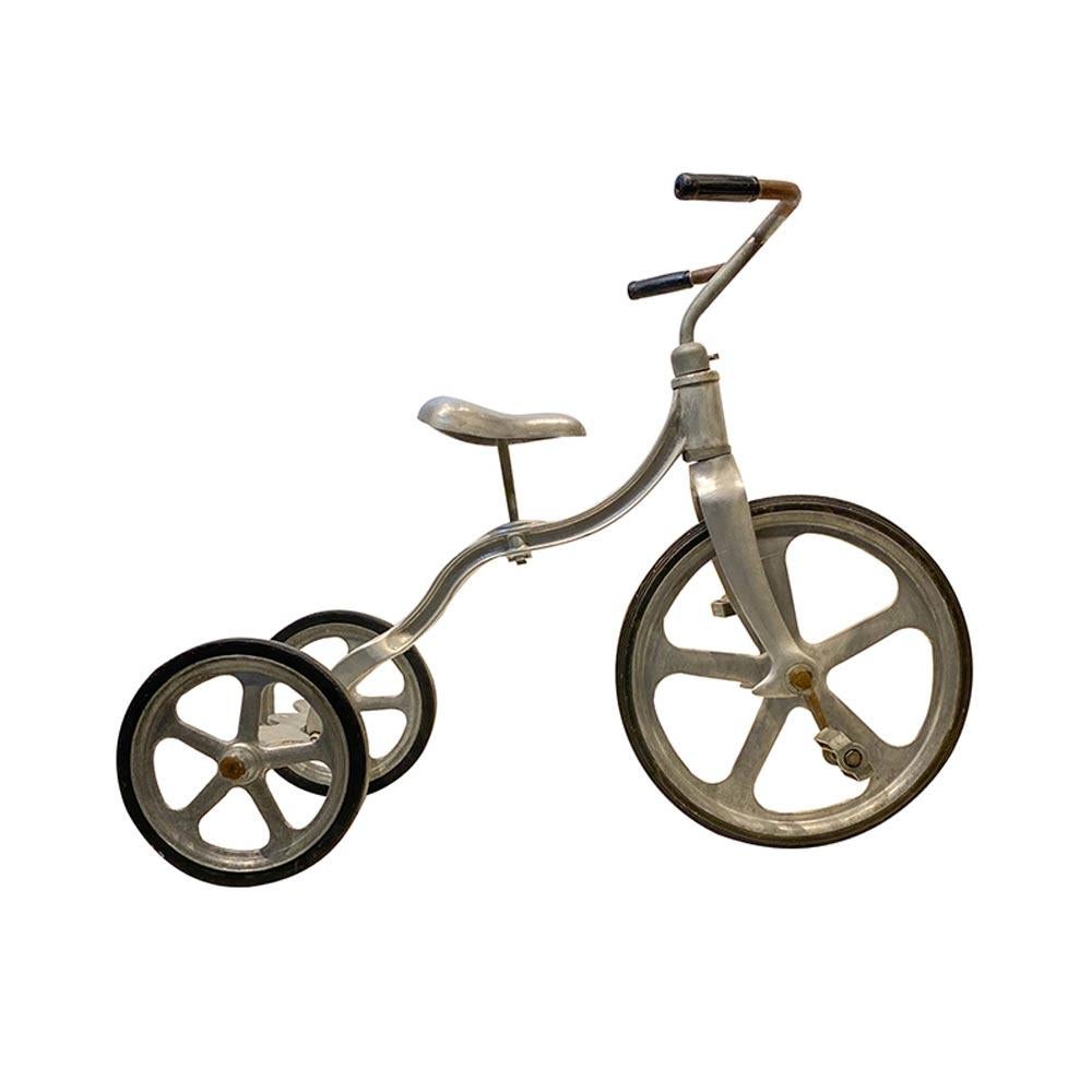 1950s convert-O bike cast aluminum tricycle with rubber wheels. Industrial era / Jet age design. Manufactured by Anthony Bros. - Designed by Tony Anthony, the rear axel deck can be removed and replaces with one of the two rear wheels converting it