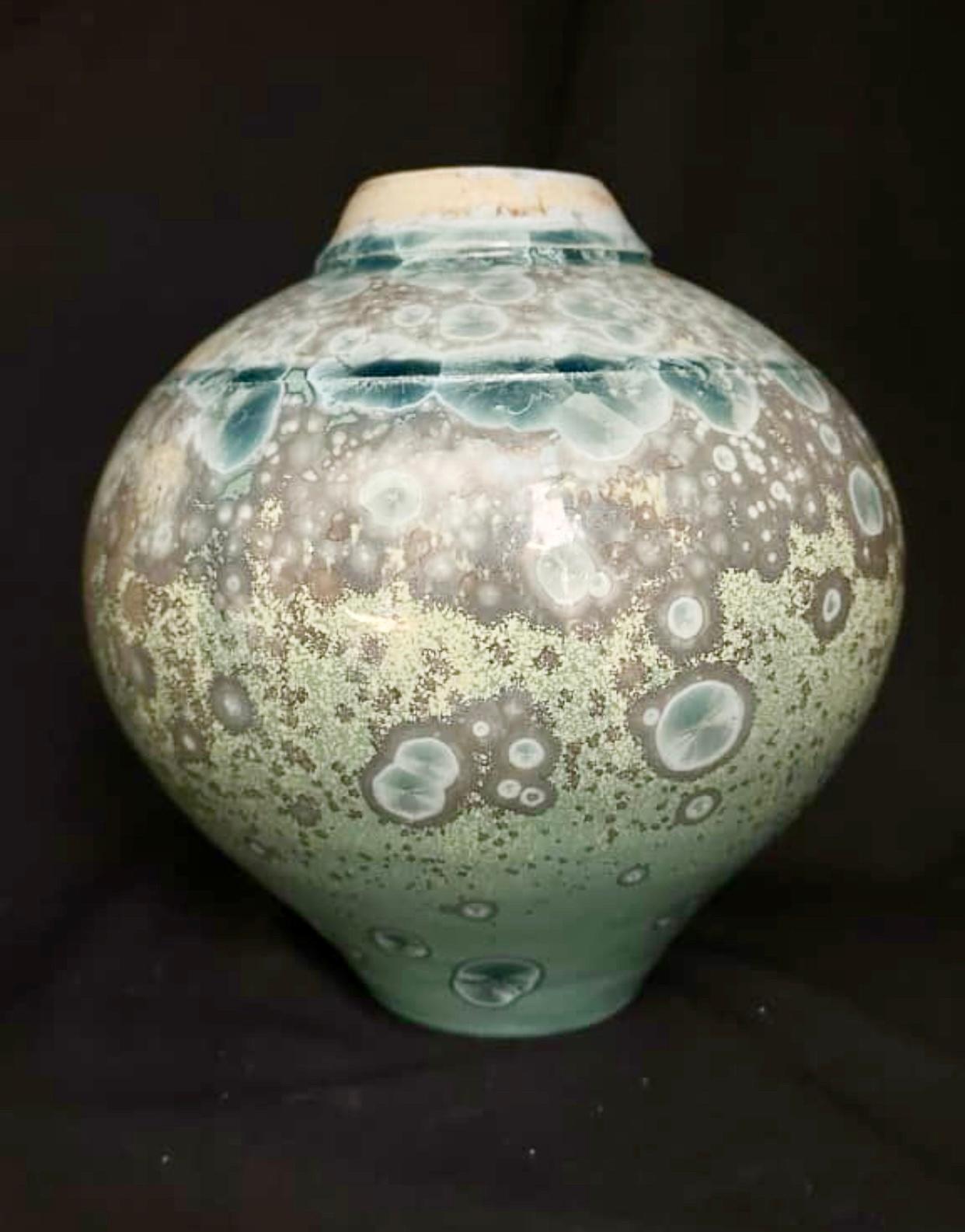 Porcelain vase by Australian ceramicist Anthony Conway, 1989. Conway began working as a potter or ceramicist in the early 1980s. This vase is uniquely finished in his signature crystalline glaze. The blue/green hues explode from the gray base color