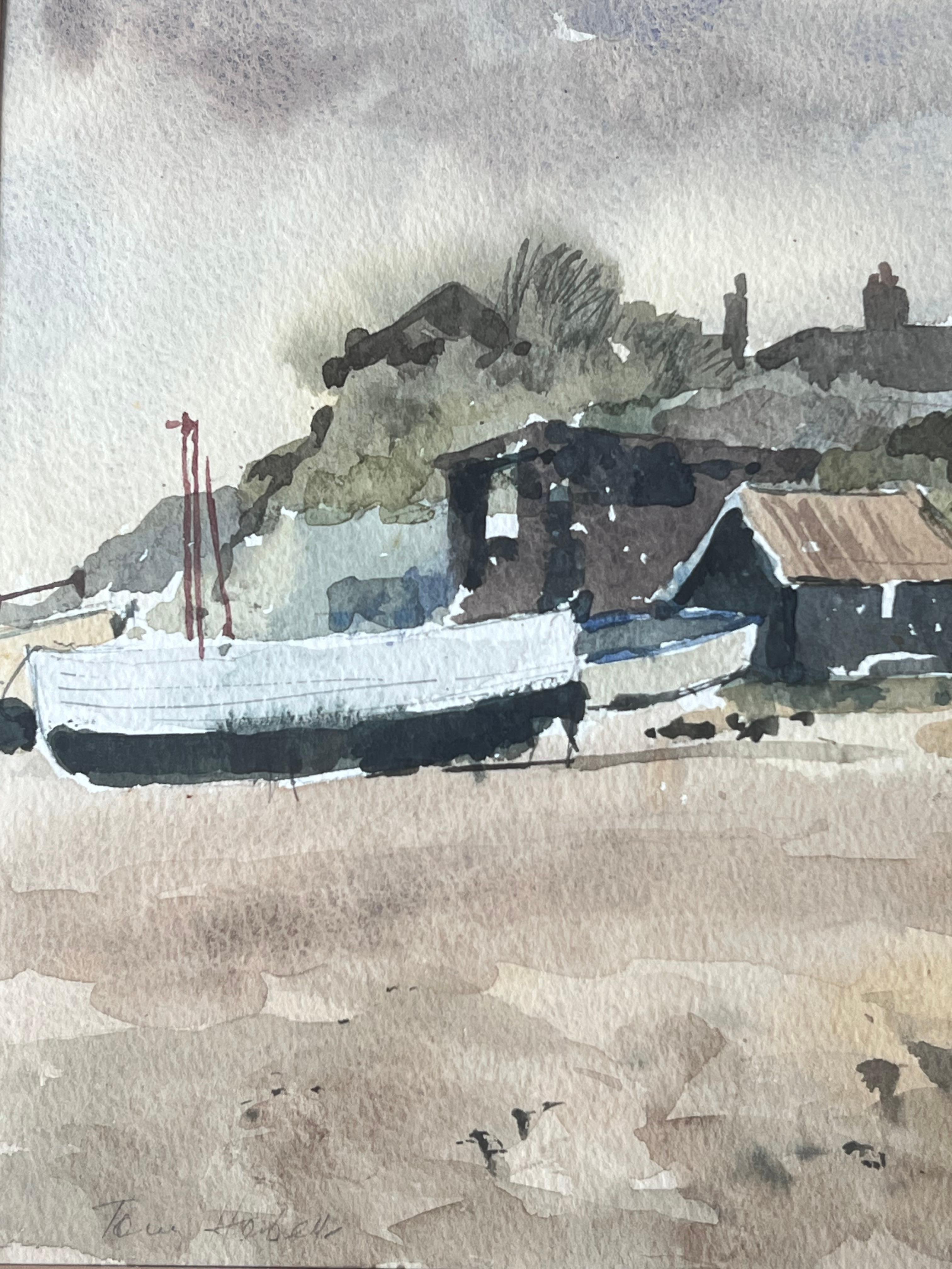 Boats Docked on Shore By Weathered Wooden Sheds with Rusted Roofs Watercolour - Gray Landscape Art by Anthony Herbert