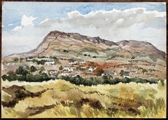 Mountain Village with Grassy Foreground and Blue Sky Black Rock Sands Wales