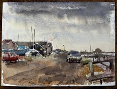 Southwold Harbour with Boatsheds Moored Vessels Peugeot Car and Cloudy Sky