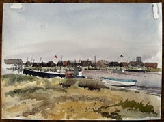 Walberswick Boats and Fishing Huts on the Riverbank with Grasses and Red Flag