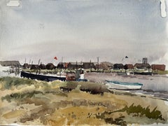 Walberswick Boats and Fishing Huts on the Riverbank with Grasses and Red Flag