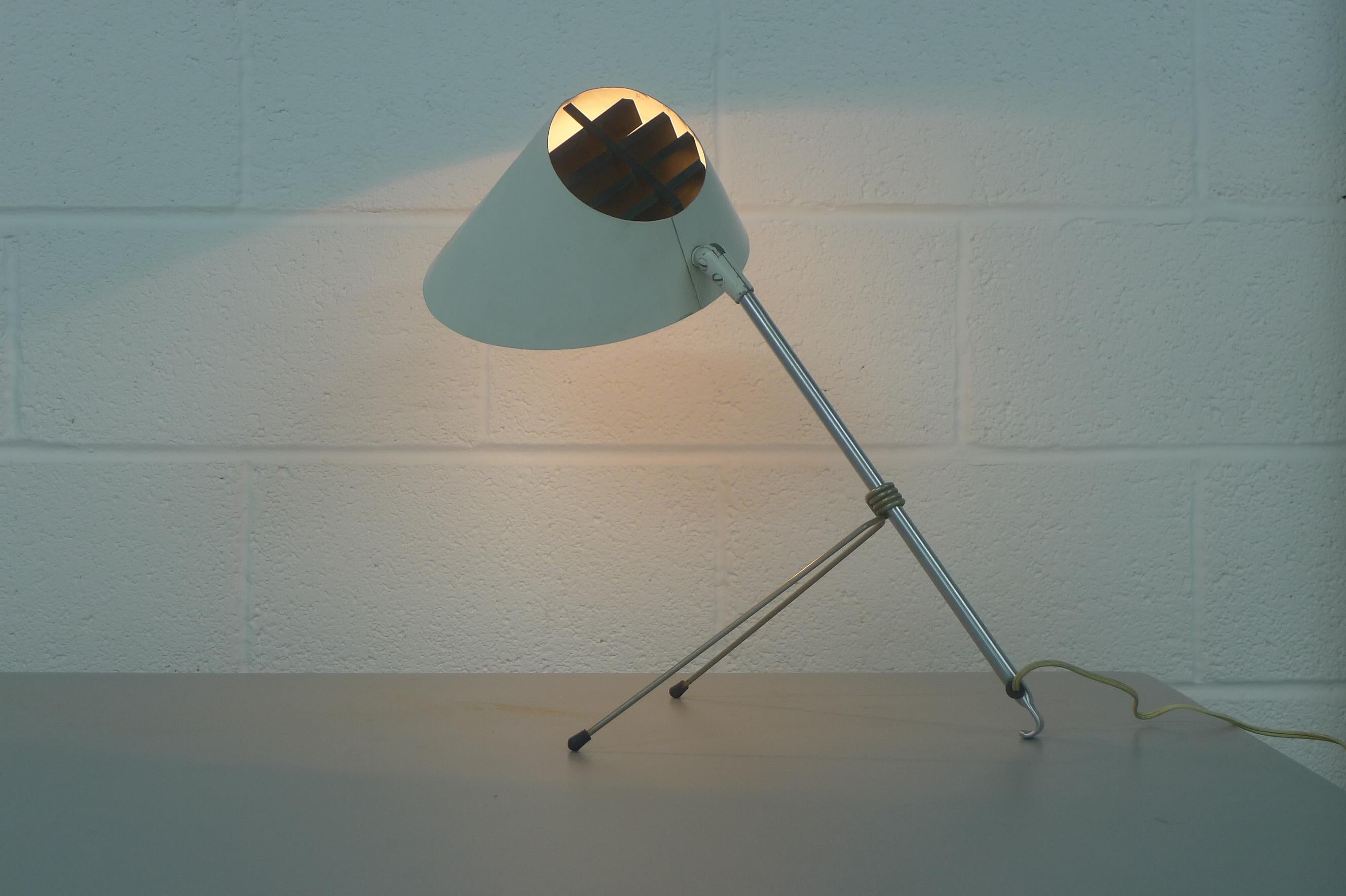 Anthony Ingolia table or wall lamp for thre Heifetz Manufacturing Co. USA circa 1951. Steel , nickel aluminum and enamel construction. Articulating and pivoting shade, height adjustable by moving the legs along the stem.
Produced as a result of a