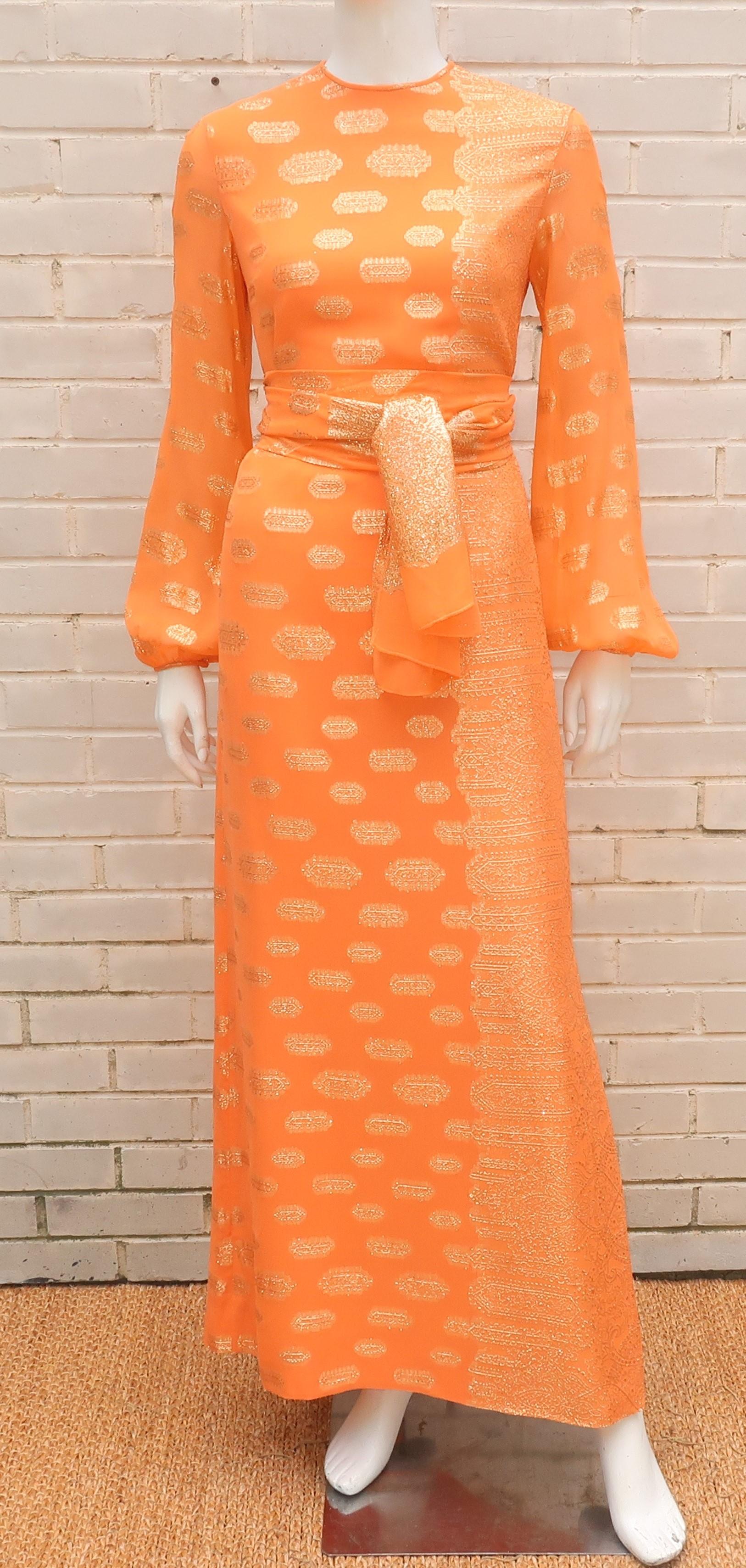 1970's Anthony Muto maxi evening dress in a wonderful cantaloupe orange georgette fabric embellished with exotic gold lamé threading.  The comfortable sheath style design zips and hooks at the back with sheer sleeves and a full lining through the