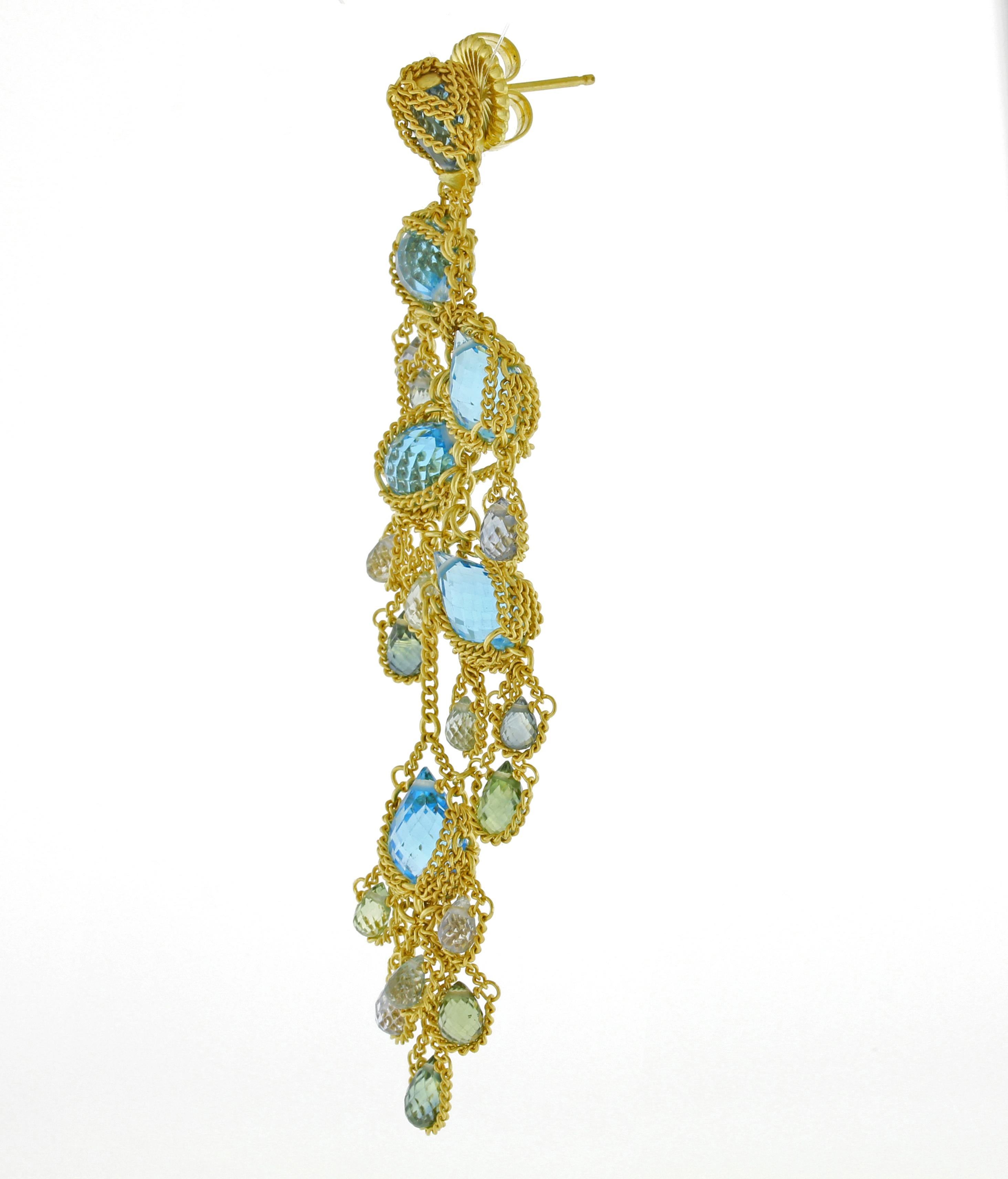 From World-famous jewelry designers Anthony Camargo and Nak Armstrong, these are handmade multi gemstone drop earrings.  The earrings contain topaz, aquamarine and tourmaline gemstones.
♦ Designer: Anthony Nak
♦ Metal: 18 karat yellow gold
♦
