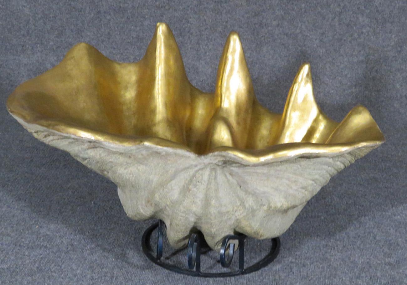 This is a superbly designed and naturalistic scallop shell with a French water-gilt gold leafed interior. This oozes luxury and is large at 32 wide x 21 deep x 17 tall. This would work well as a centerpiece or decorative accent for a large coffee
