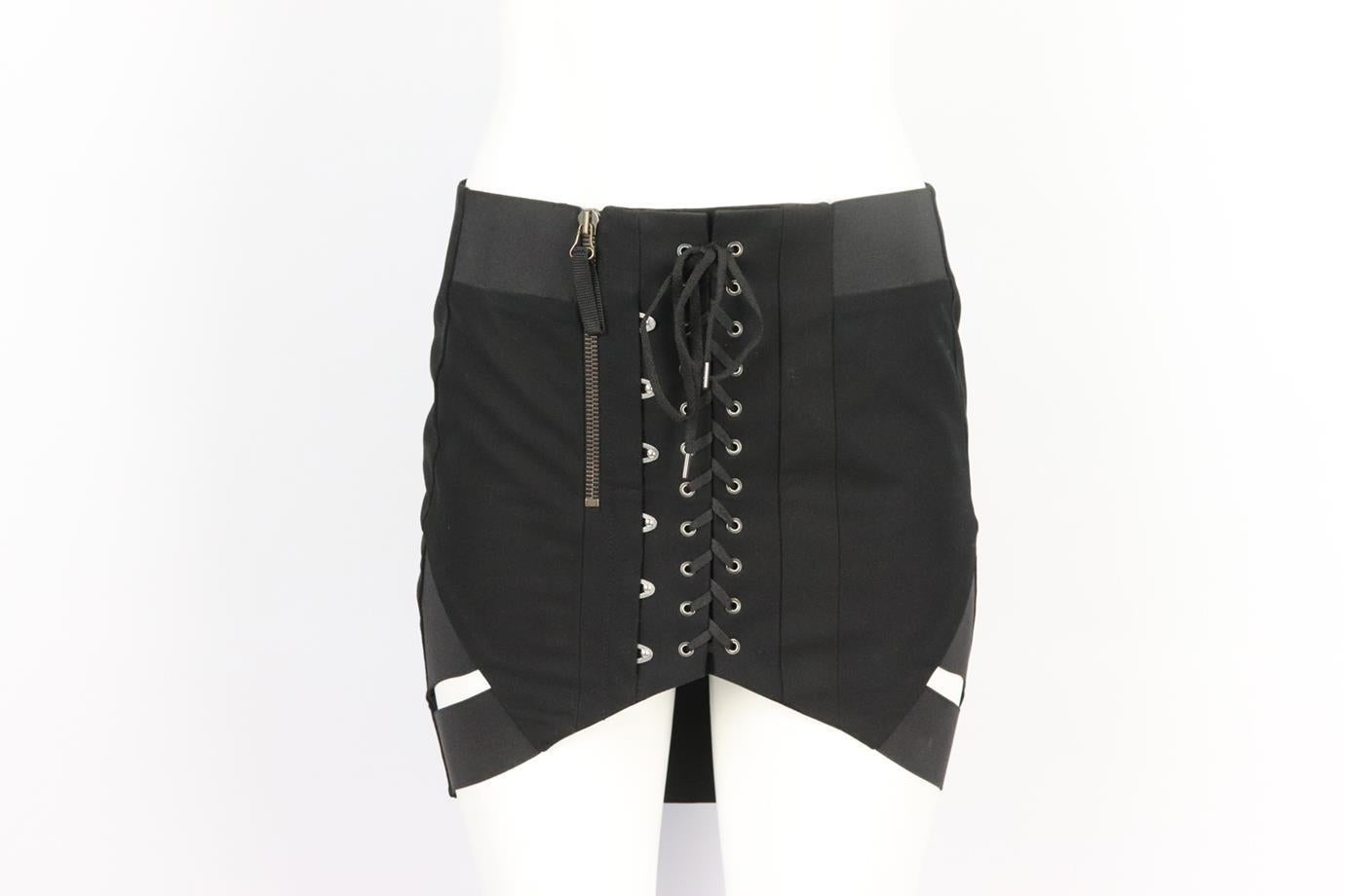 Anthony Vaccarello asymmetric lace up wool mini skirt. Black. Zip fastening at side. 100% Wool; trim: 100% zamac. Size: FR 36 (UK 8, US 4, IT 40). Waist: 30 in. Hips: 34.8 in. Length: 16.4 in. Very good condition - No sign of wear; see pictures.