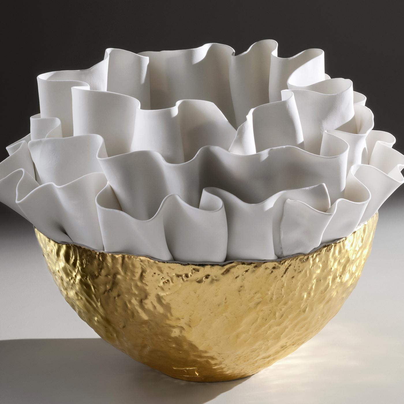 A work of art that is both functional and decorative, this bowl was introduced at Milan Design Week, 2019. It is inspired by sinuous seaweeds with a textured bottom painted in 23-karat gold and a top that showcases the mastery of Fos Ceramiche