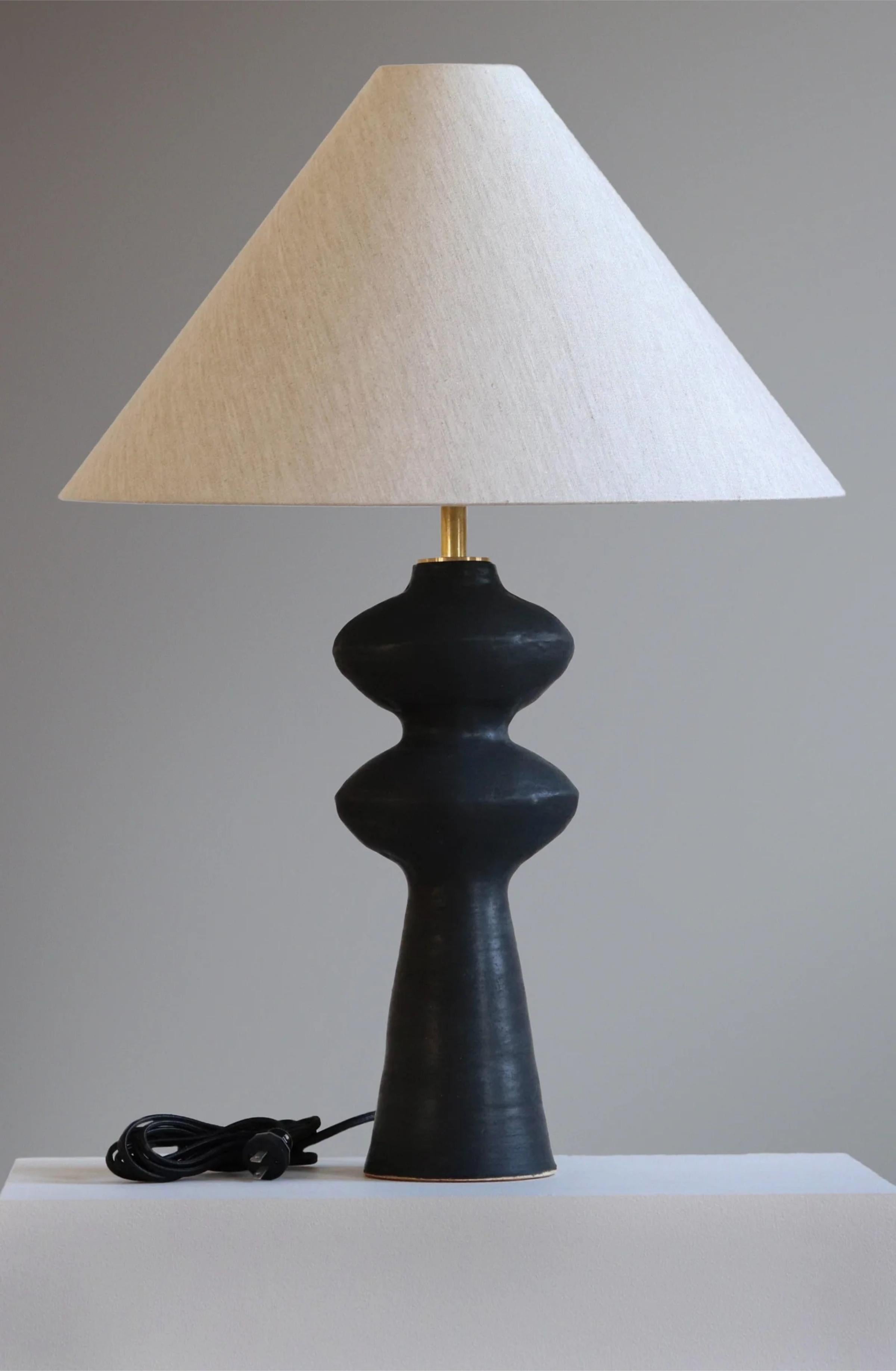Anthracite Pollux 32 Table Lamp by  Danny Kaplan Studio
Dimensions: ⌀ 56 x H 82 cm
Materials: Glazed Ceramic, Unfinished Brass, Wax Paper

This item is handmade, and may exhibit variability within the same piece. We do our best to maintain a