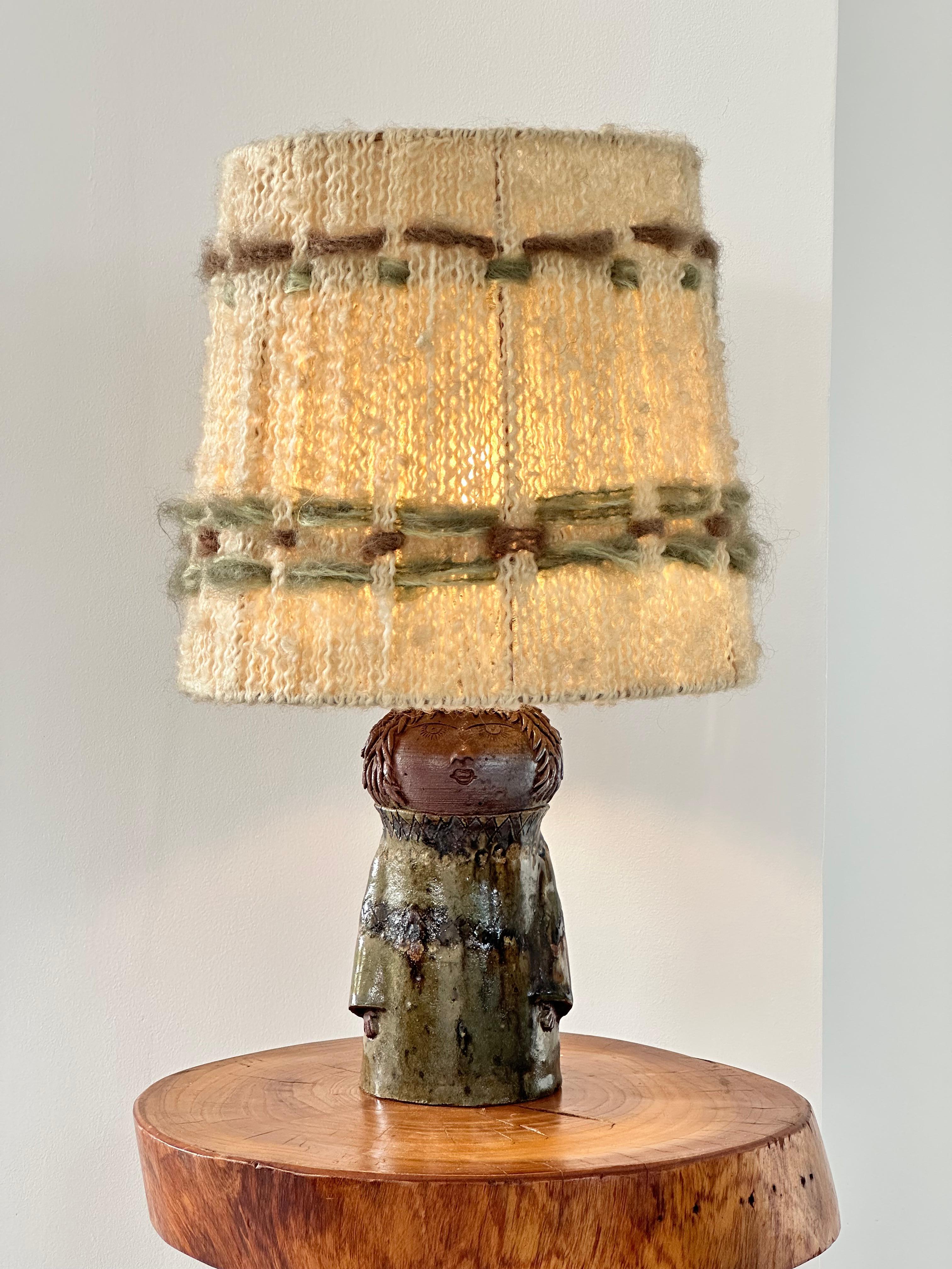 This Anthropomorphic table lamp is a unique work.

From the La Borne workshops this lamp is in enameled stoneware.

The lamp is marked with a signature made at the tip and hollow. (dimensions of the lamp excluding lampshade: diameter 9 cm, height 19