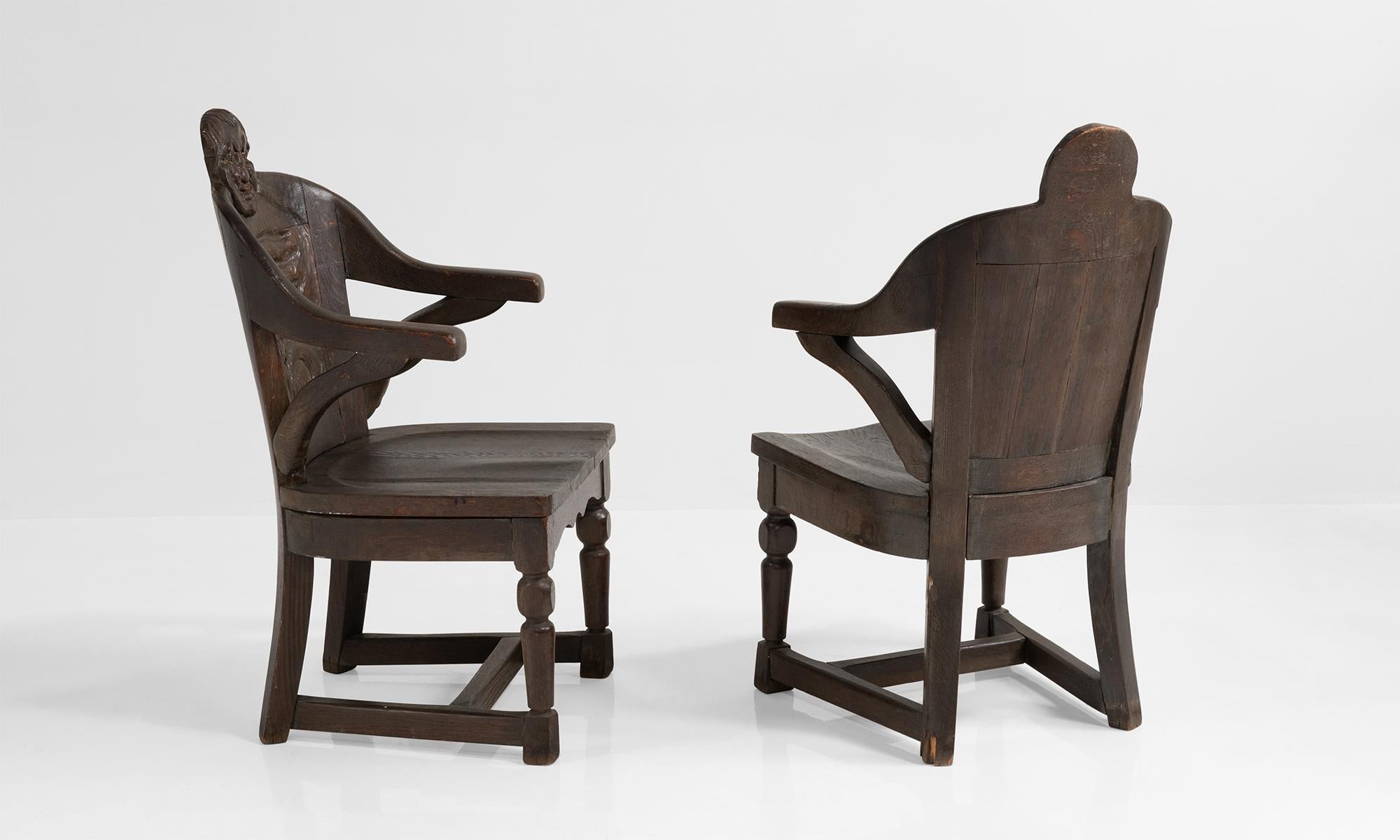 Carved solid oak chairs with male and female faces at the crown.