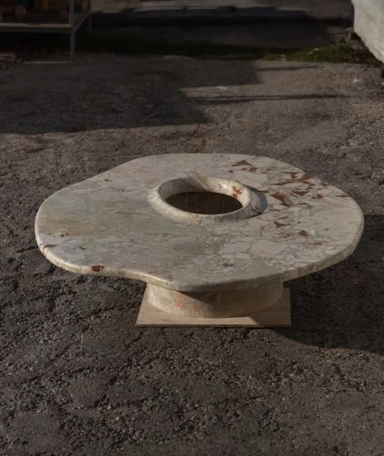 Design for Conversation and Connection. More than just a table, the Anti coffee table transforms the ordinary into the extraordinary. The hole in the center suggests that the object itself may not be the focal point, but rather an invitation to
