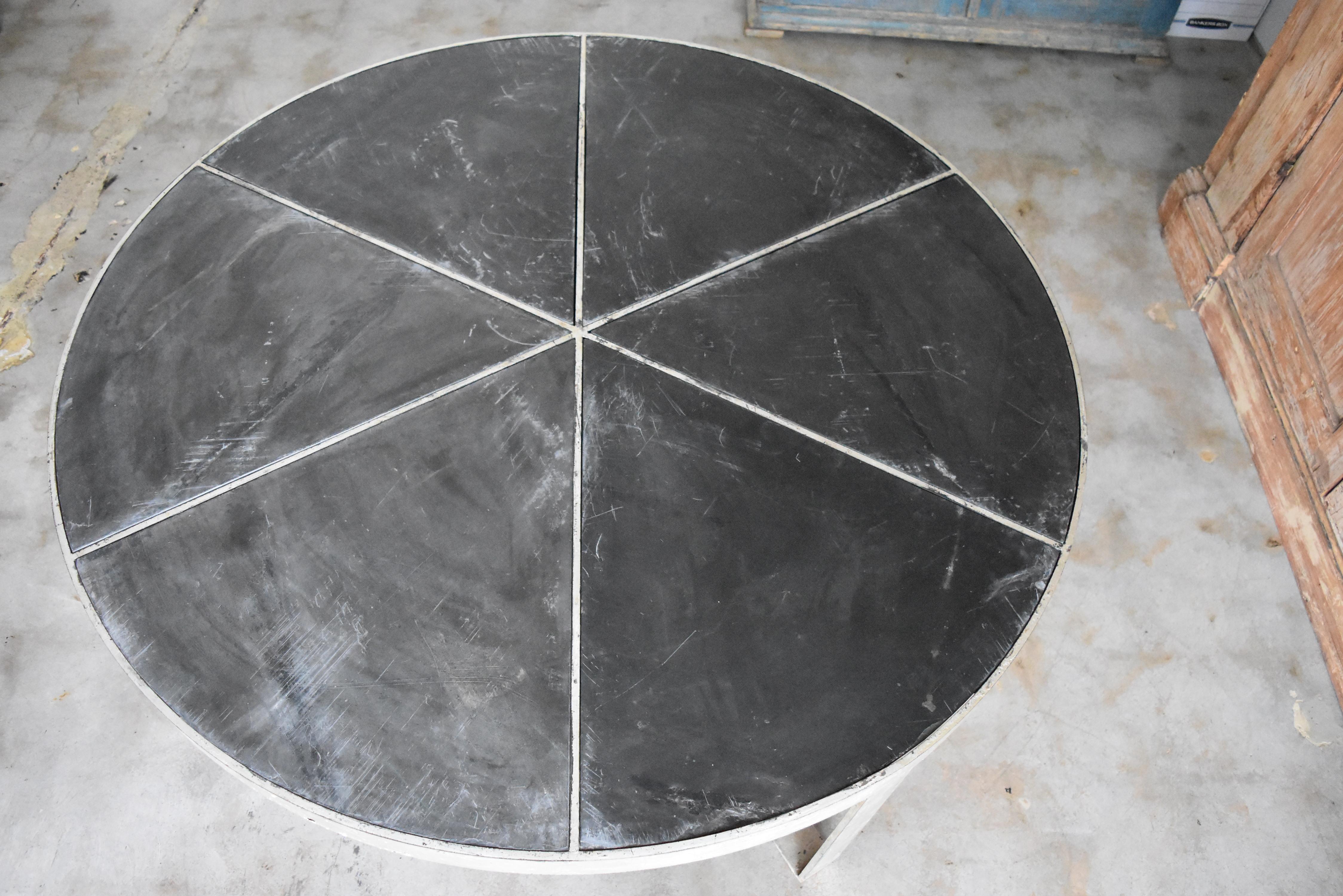 Our very own design round coffee table with silver overlay and inset black slate. The slate pie pieces come out for transport. This is very heavy gage iron and over 100lbs. It's quite a statement piece. We also do custom sizes.