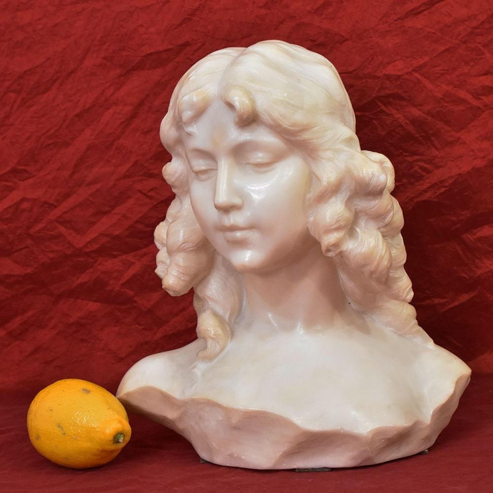 The category Antique Marble and Alabaster Sculptures, features a beautiful and refined Female Sculpture, 
depicting a Bust of a Woman, a young girl with ringlets. 
The work has its Original Patina.

The age of the ancient sculpture is from the late