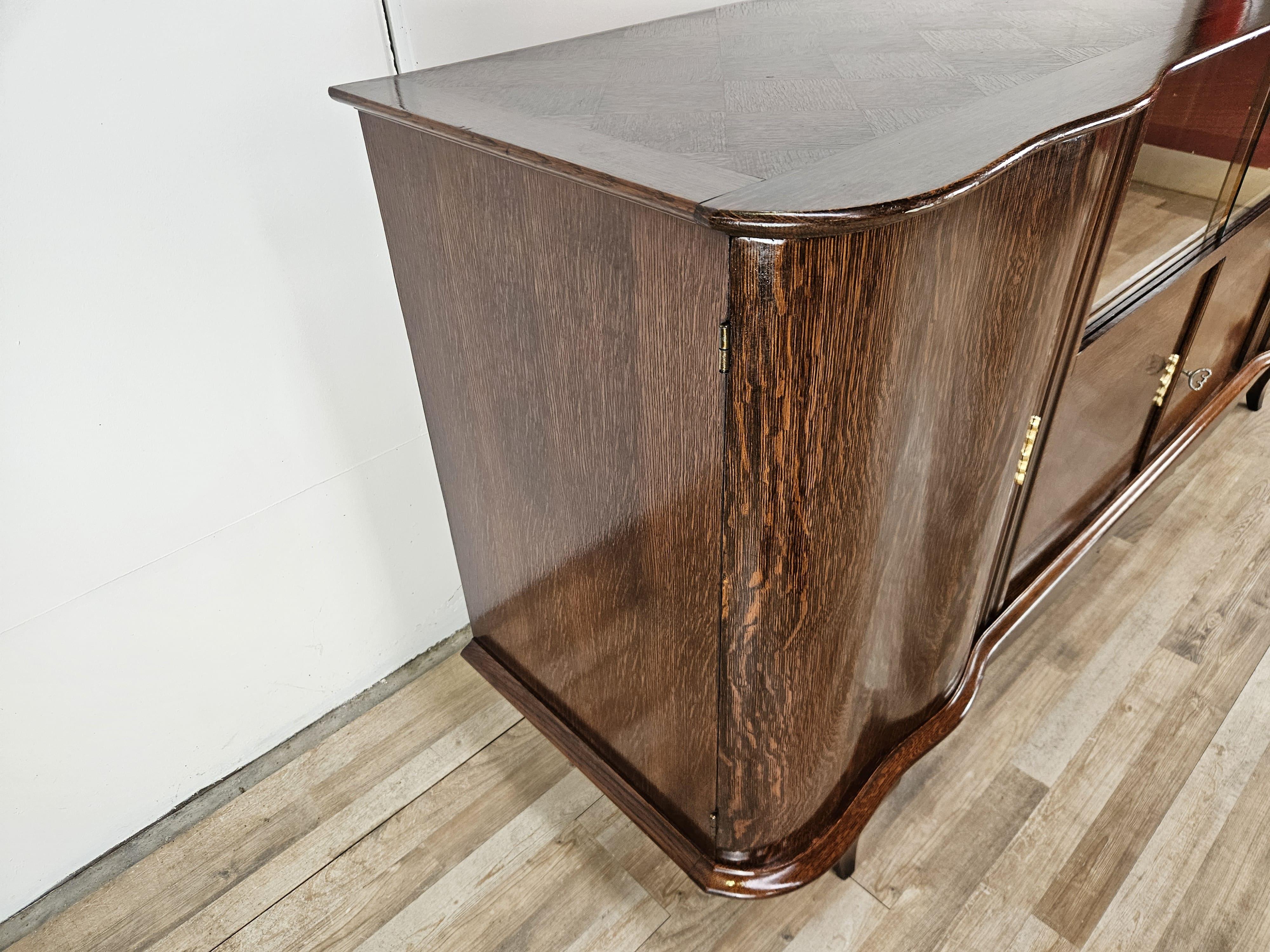 Italian Antique Art Deco 1950s oak sideboard with sliding glass and decorations For Sale