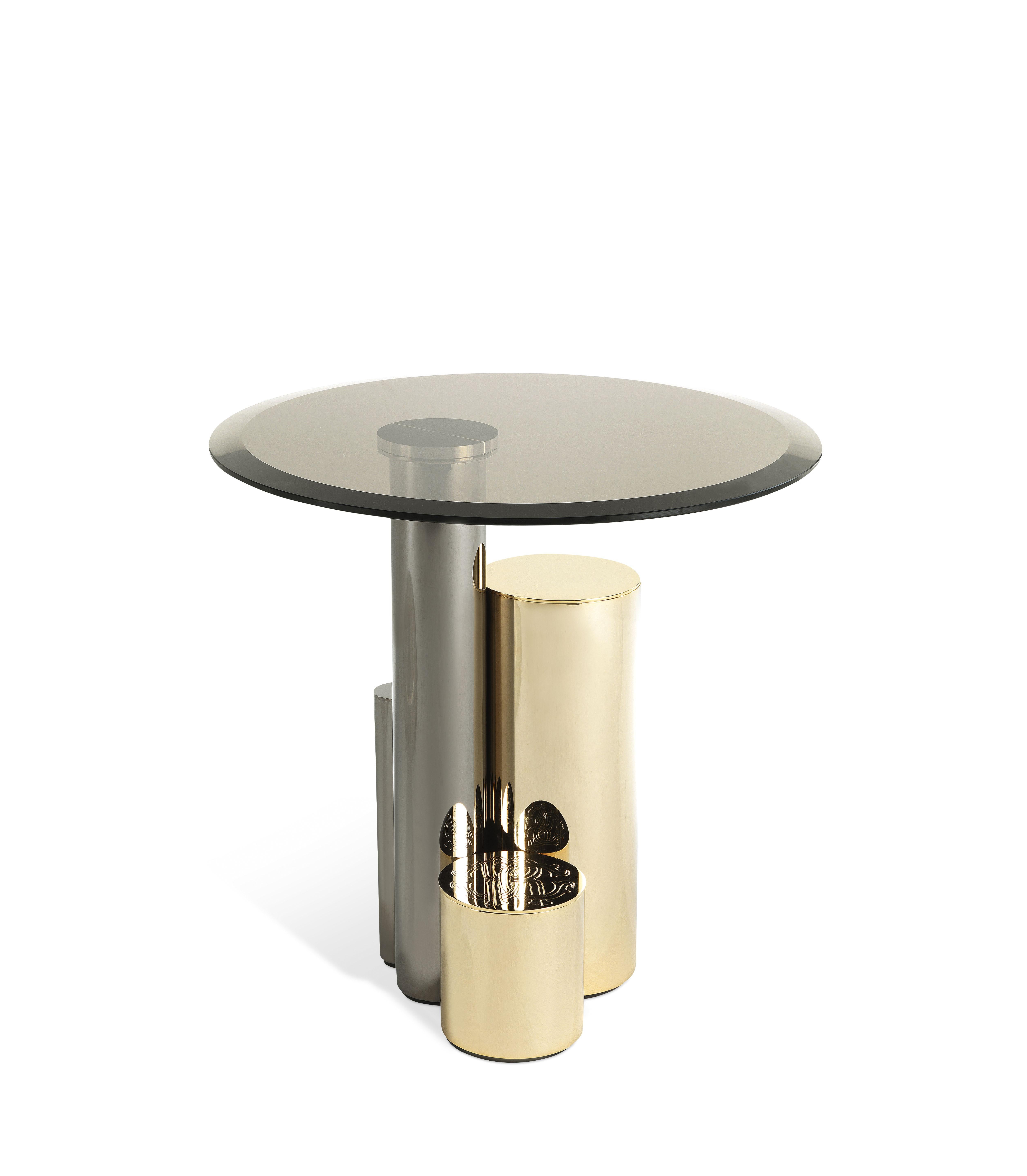Contemporary lines and precious materials for Antigua side table. The base is created by a combination of different materials and colors: a sculptural composition consisting of metal elements with different thicknesses, heights and finishes that
