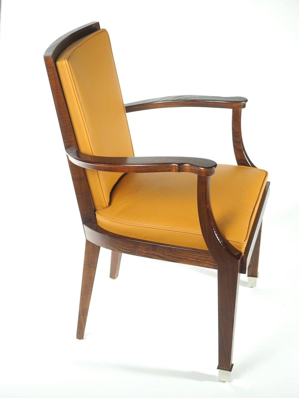 French midcentury pair of armchairs (two pairs available) designed for use in the Classe Salon of the French oceanliner Antilles, 1951. These chairs are fabricated in oak with bronze mounts. 24.5
