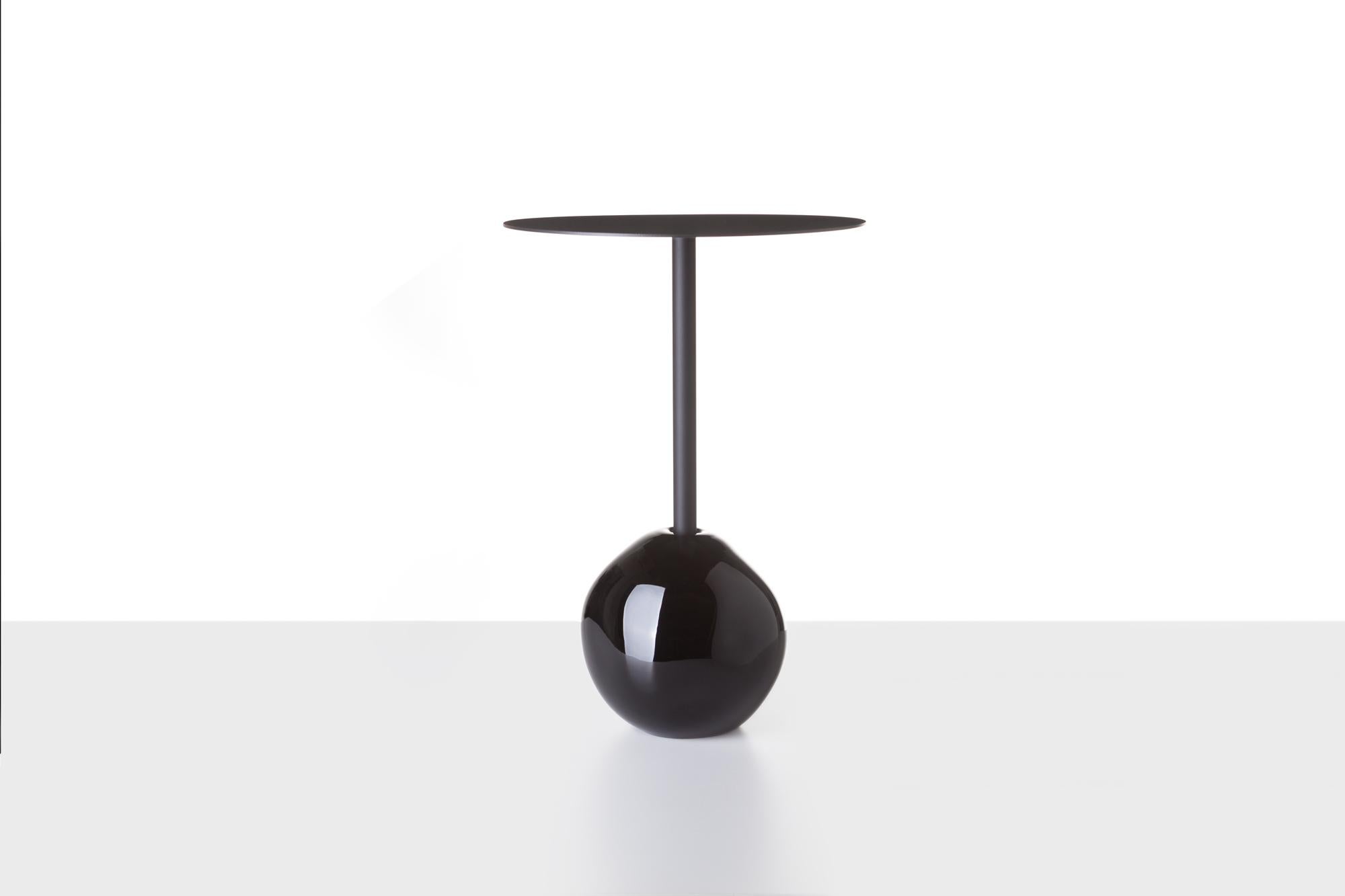 Antimatter table by Dechem Studio.
Dimensions: D 40 x H 37 cm.
Materials: glass, metal.

Based on the same principle as our Antimatter Vase and Lamp, this table is comprised of a heavy and massive organic glass base and a black coated brass leg