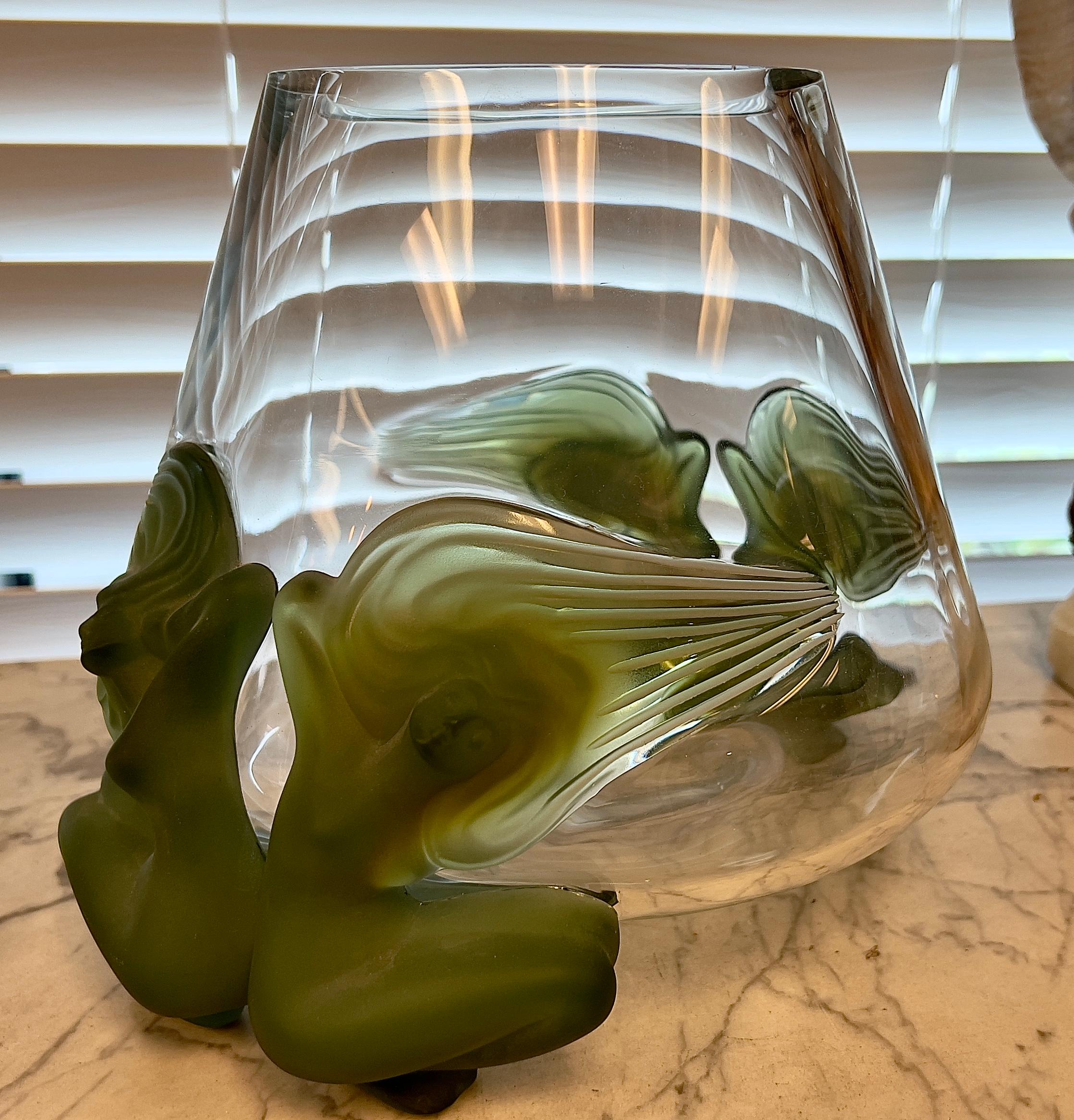 A Lalique Antinea pattern glass vase tapering cylindrical, moulded with opaline jade glass nymphs, engraved with 'Lalique France' at base.

Dimensions:
Hight: 9