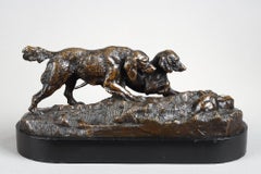Two dogs pointing a rabbit
