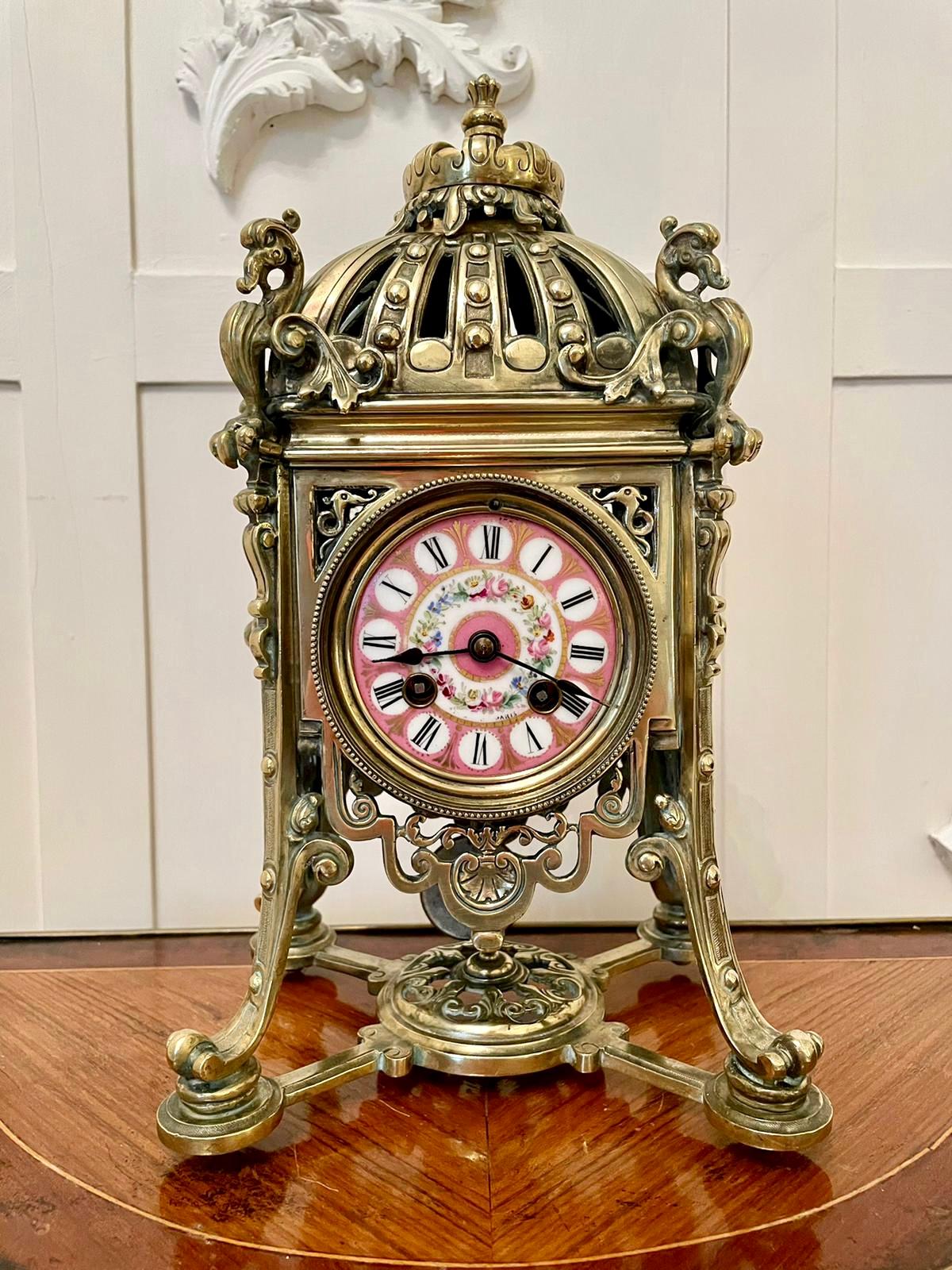 An outstanding antique 19th century French eight day brass gilt metal striking mantel clock by the premier makers of Paris, Henry Marcs and Japy Freres. The pink porcelain dial is an exquisite example depicting a beautiful wreath of pretty flowers