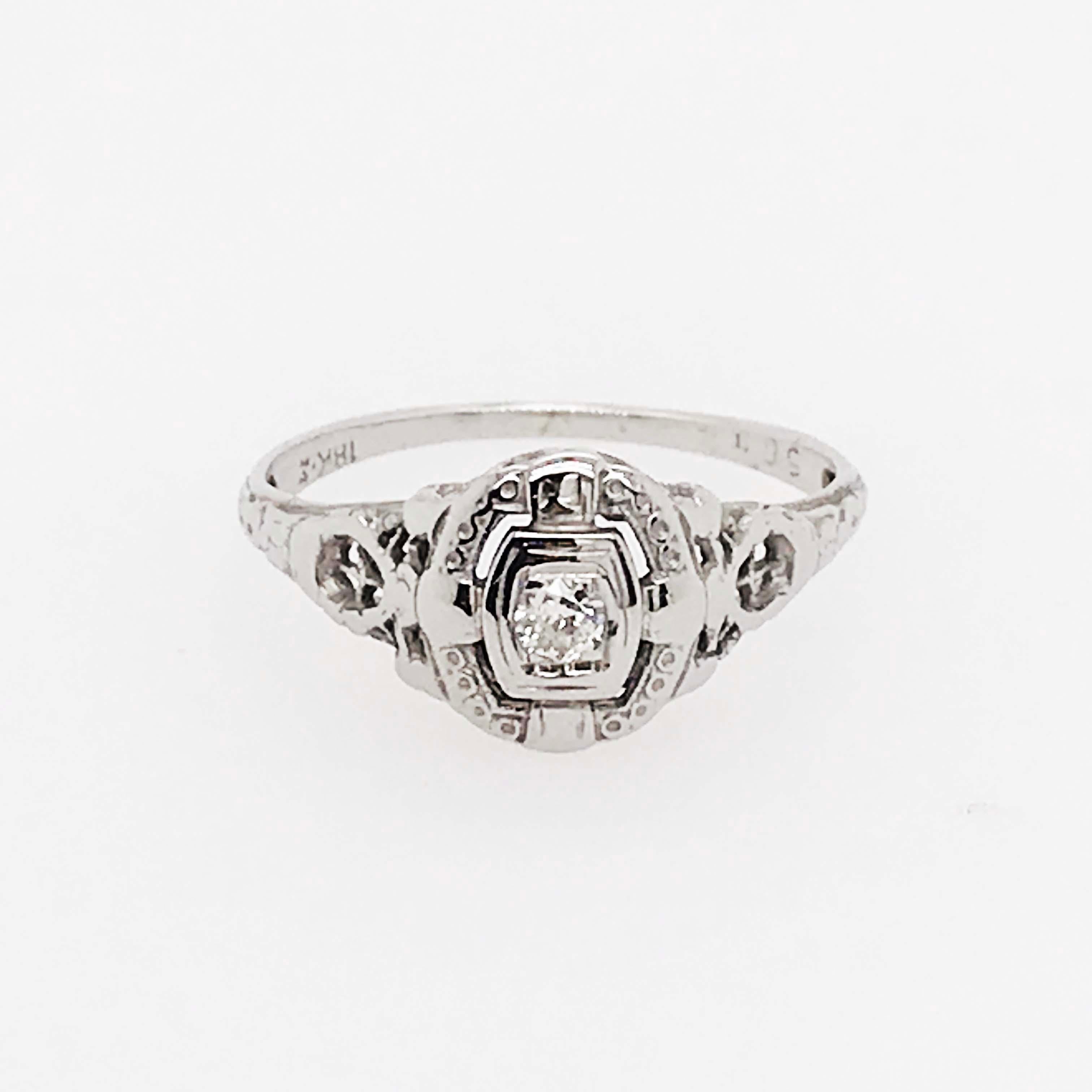 This gorgeous antique diamond engagement ring is a true estate piece and in amazing condition with the original center diamond and original 18 karat white gold. With a round brilliant diamond set in the center on a cushion shaped illusion setting.