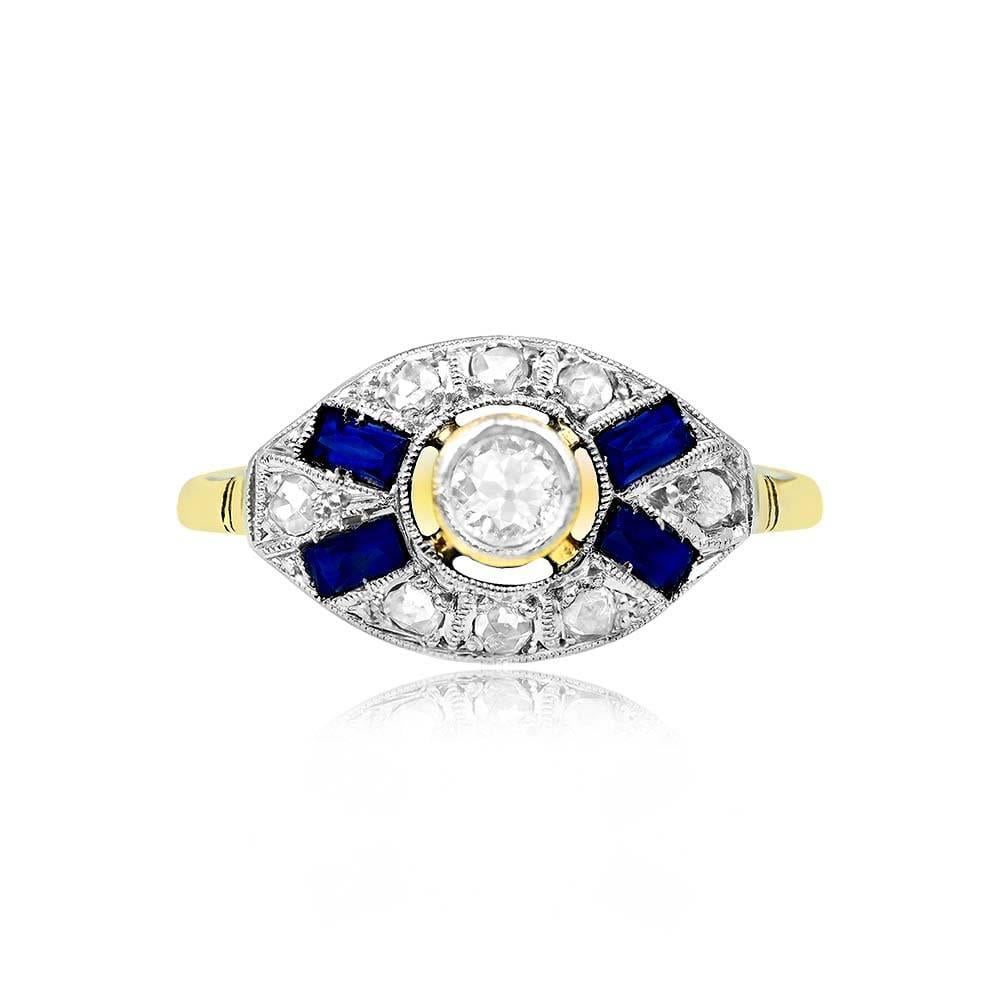 This antique engagement ring showcases a charming old European cut diamond center stone weighing around 0.15 carats, with I color and SI2 clarity. The ring is further adorned with rose-cut diamonds and French-cut baguette sapphires, totaling