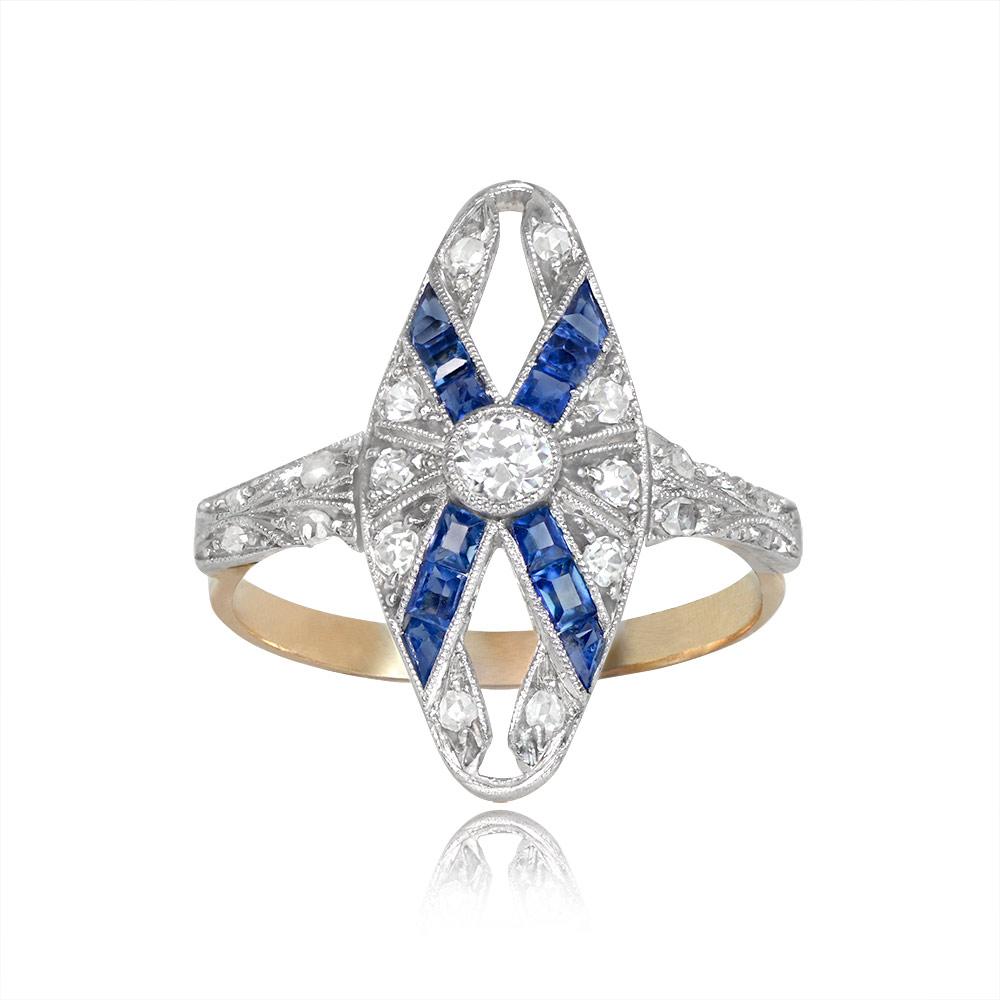 An elongated Edwardian-era ring with a bezel-set old European cut diamond weighing around 0.15 carats. Rows of caliber cut sapphires accentuate the center diamond. The sapphires weigh approximately 0.36 carats. Additional single and rose-cut