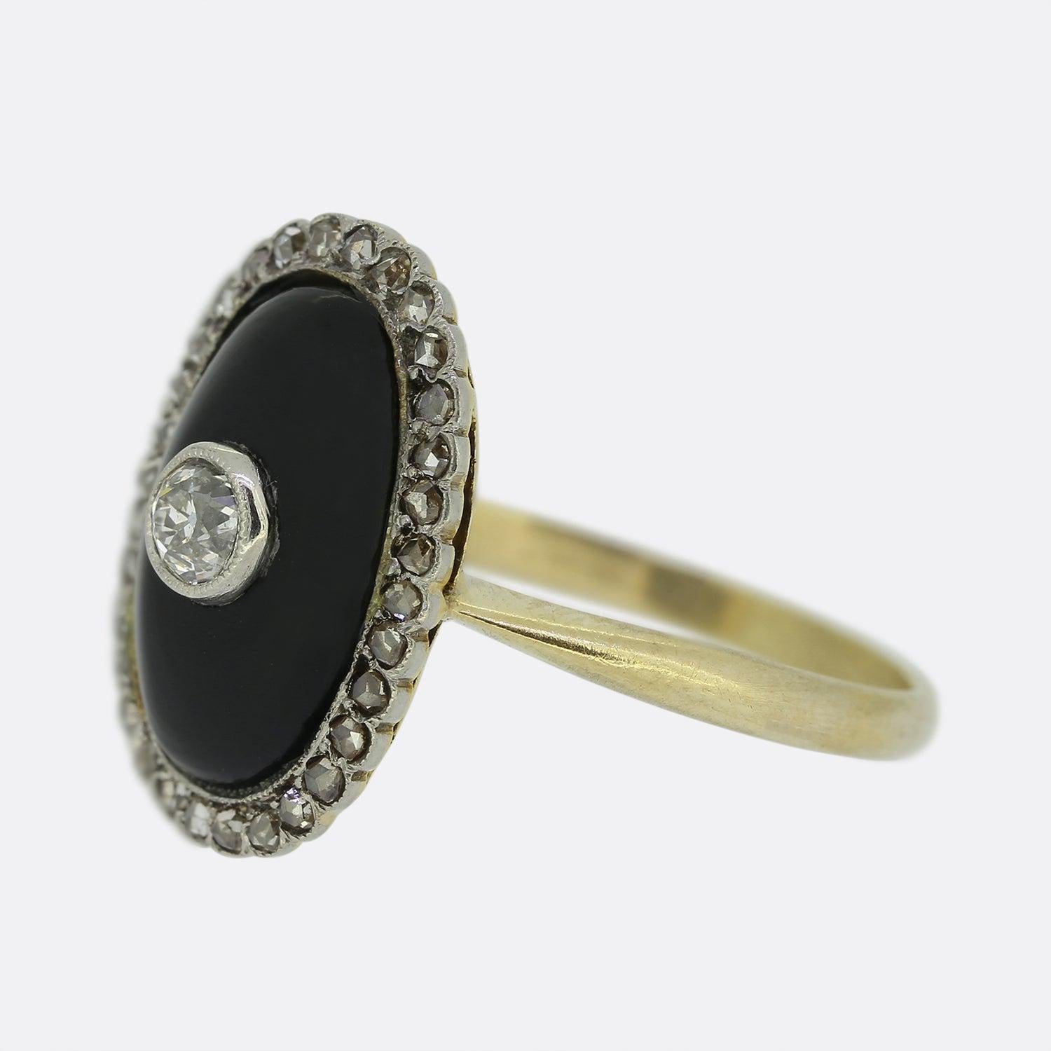 Here we have a wonderfully crafted diamond and onyx ring from the early stages of the 20th century. At the centre of an oval shaped onyx backdrop we find a single milgrain set old cut diamond which is surrounded by a frame of rose cut diamonds atop