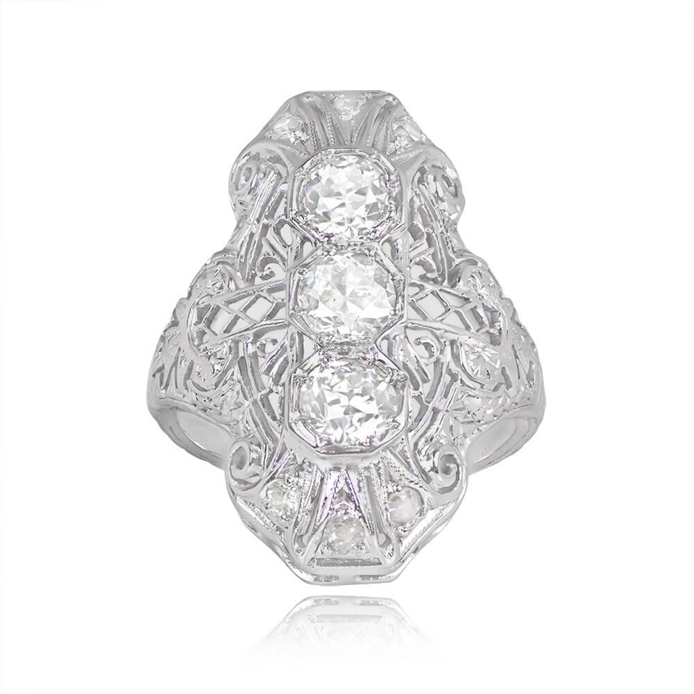 This antique Art Deco ring showcases three old European cut diamonds, each around 0.30 carats, set north-south. The center stones have J color and VS2-SI1 clarity. The platinum mounting features intricate openwork, with additional single-cut