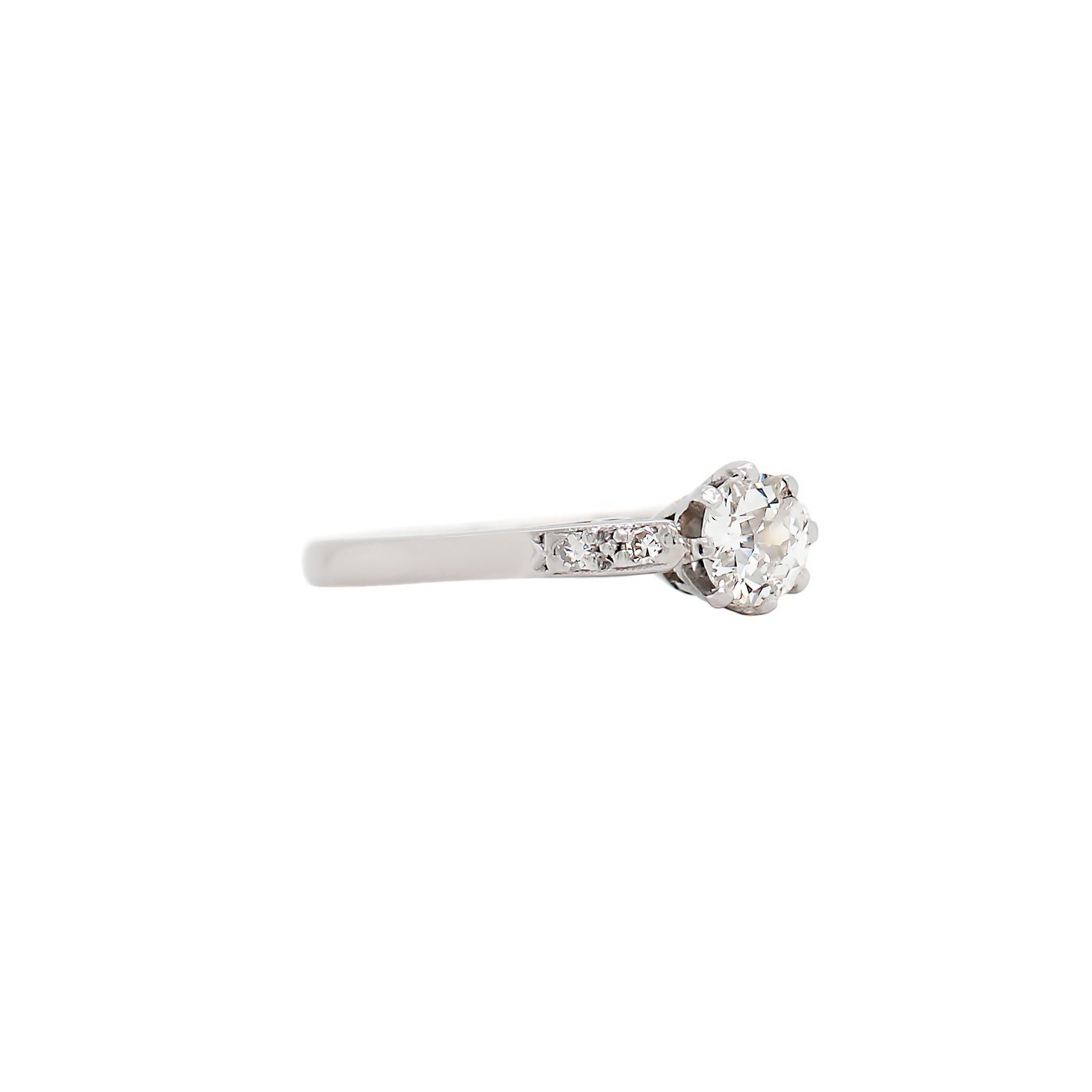 This beautiful Edwardian engagement ring features a 0.40ct old cut diamond mounted in an eight claw open back setting, accompanied by two eight cut diamonds grain set on either shoulder with an approximate total weight of 0.04ct. Stamped 18CT PLAT.