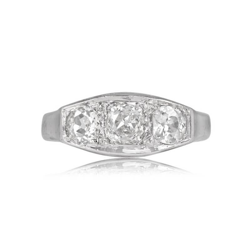Platinum & Gold Three-Stone Ring: An elegant fusion of platinum and 18k white gold, showcasing an antique cushion cut diamond flanked by two old mine cut diamonds. The central cushion cut weighs 0.45 carats, boasting J color and VS2 clarity. Two