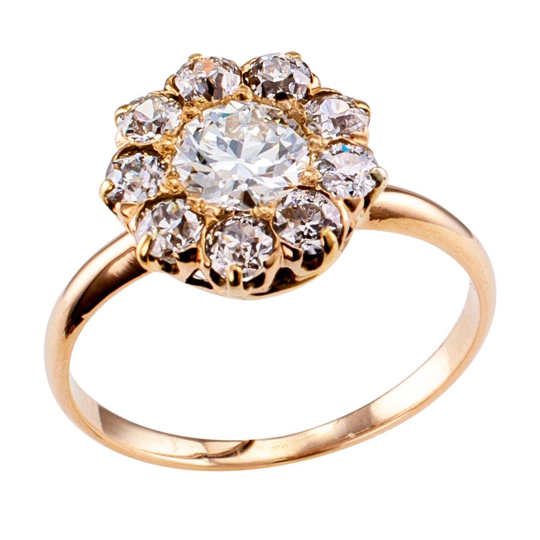 Antique 0.50 carat diamond and gold cluster engagement ring circa 1900. Centering upon an old European cut diamond weighing approximately 0.50 carat, approximately H color and VS clarity, within a conforming border set with nine similarly cut
